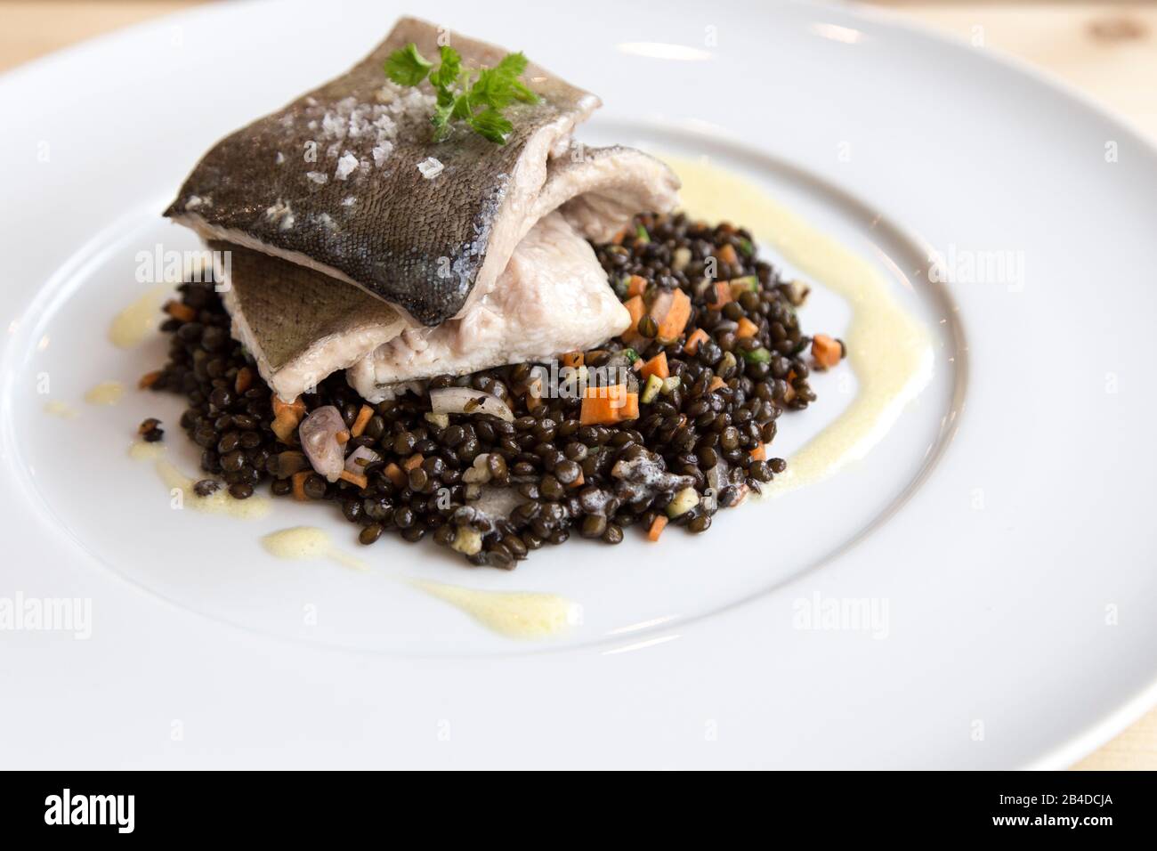 Trout filets with lentils on white polate Stock Photo - Alamy