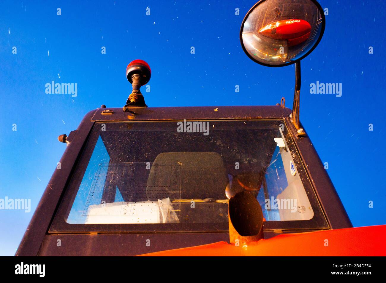 A very striking perspective, with equally bold colours. Very creative approach to an unusual subject a digger under a starlit sky. Stock Photo
