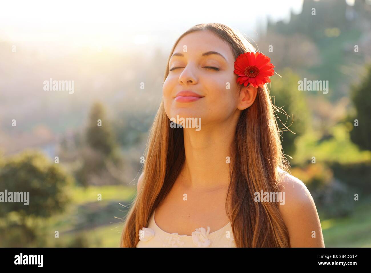 Attractive spring girl smiling with closed eyes taking deep breath. Positive human emotion face expression feeling life perception success peace mind Stock Photo