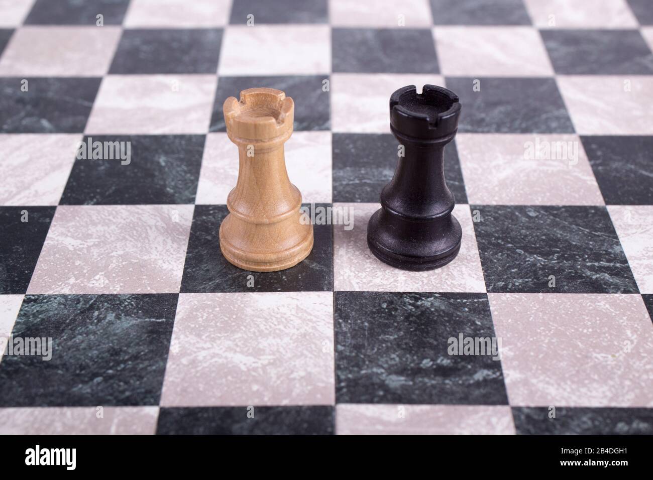 black and white wooden rooks on chessboard Stock Photo