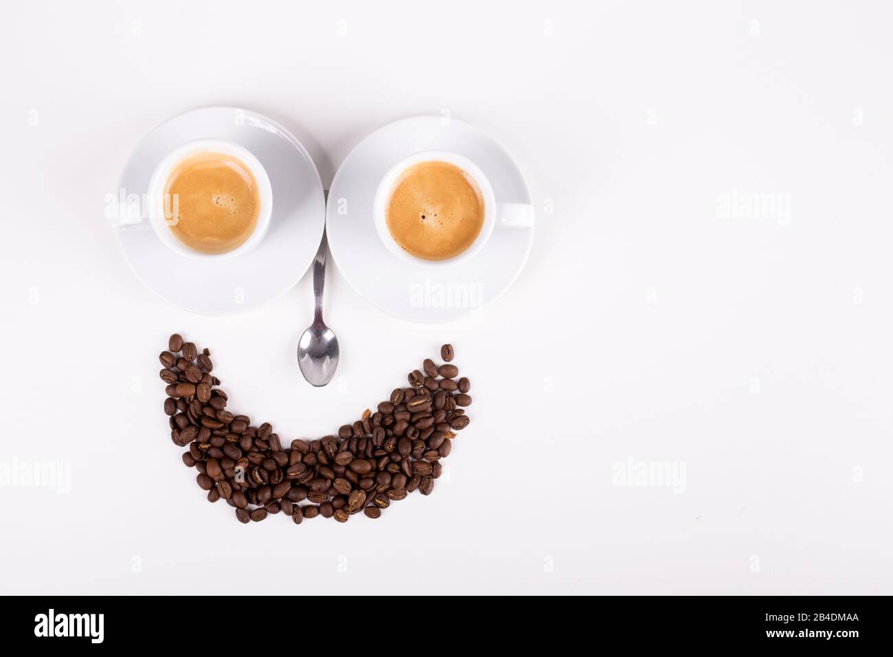 smiley made from cups of coffee on white background Stock Photo - Alamy