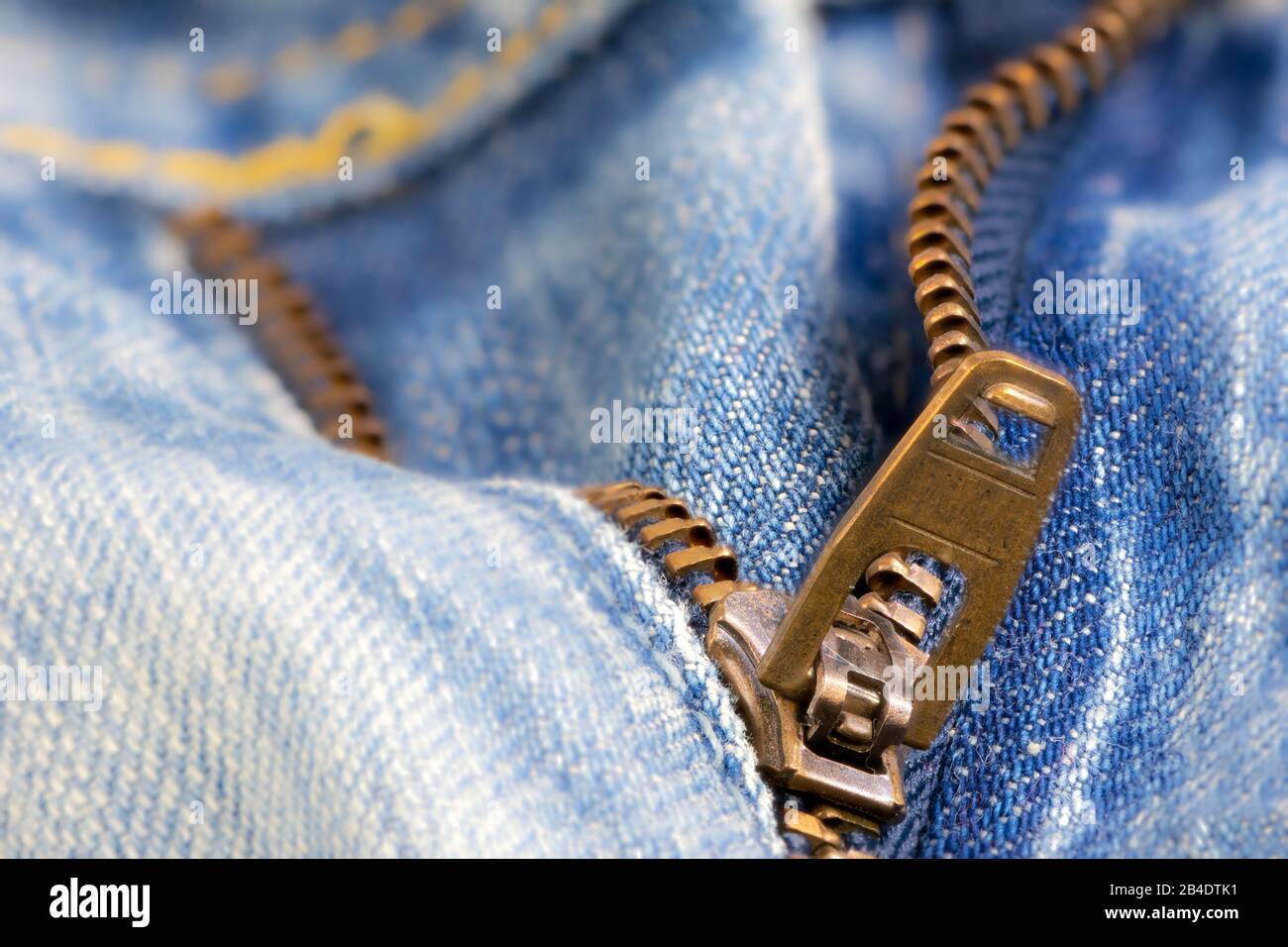 Open zipper of a worn out blue jeans Stock Photo