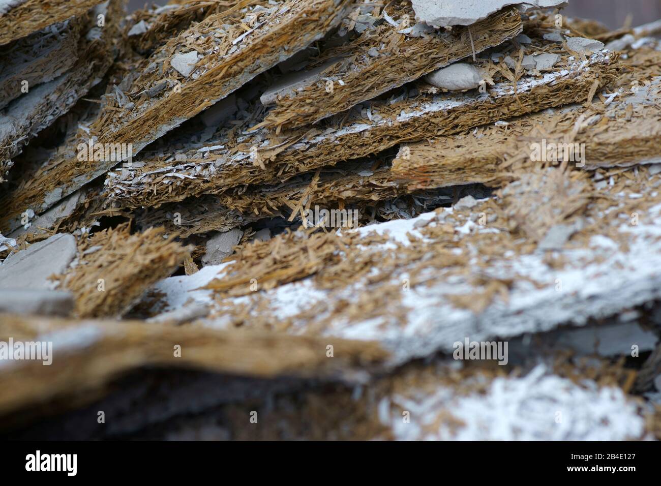 A heap of poured and crushed building rubble in the form of wood wool lightweight panels. Stock Photo