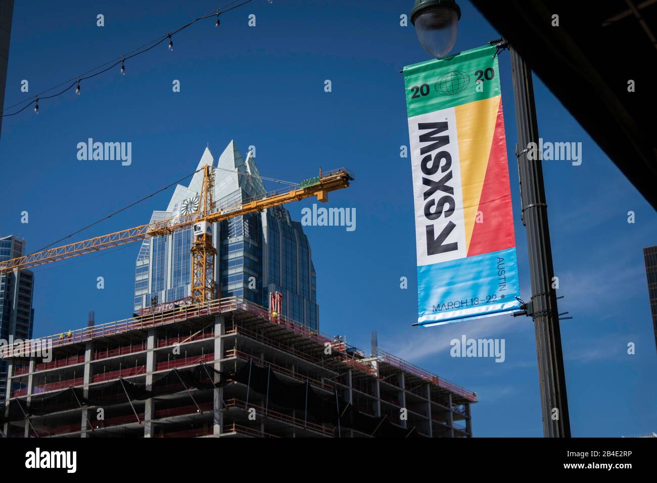 Austin, Texas - March 6, 2020: 2020 South by Southwest (SXSW) conference and festival banner near Frost tower and construction Stock Photo