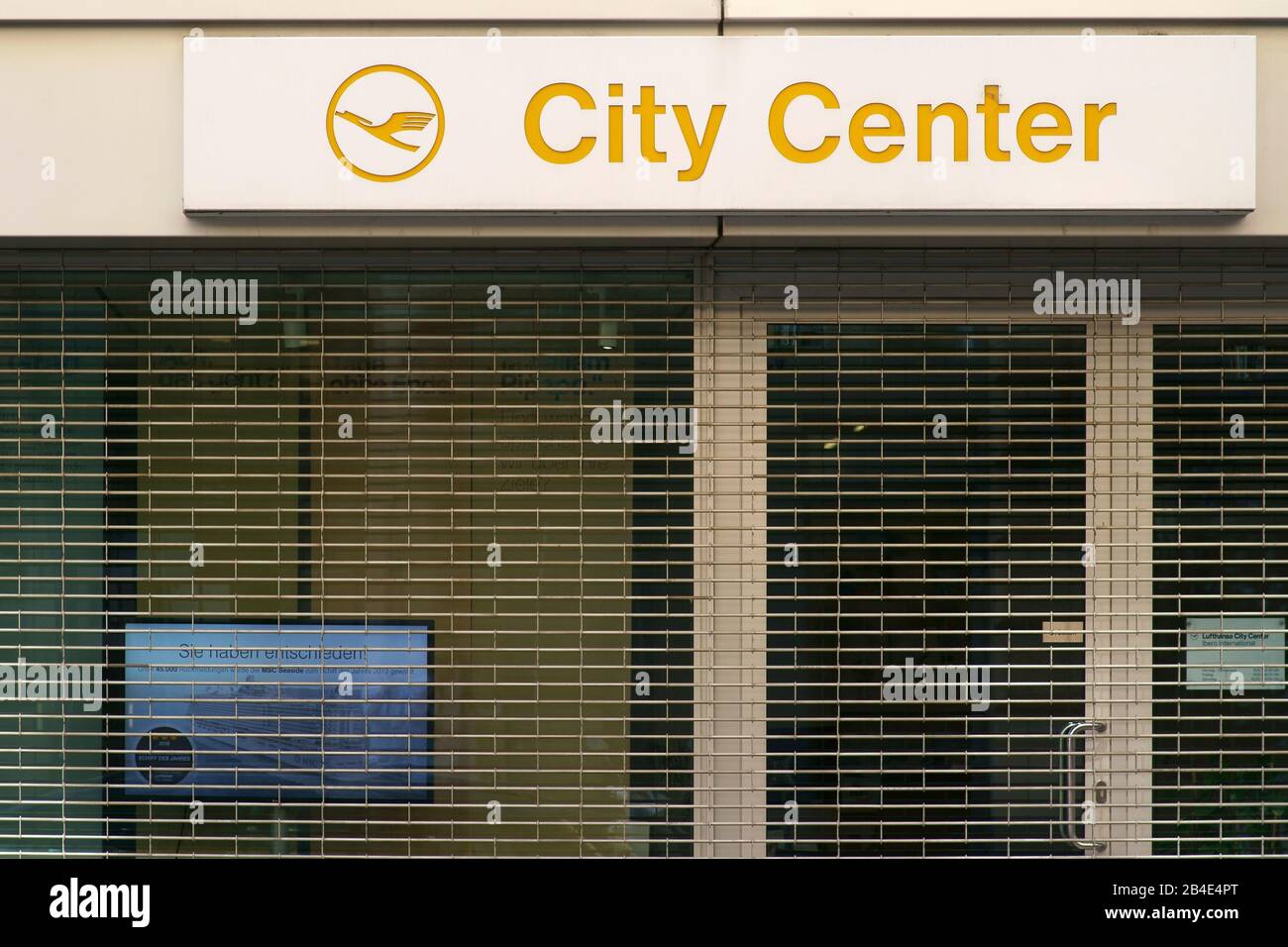 The logo of the travel agency Lufthansa City Center over the barred shop window of a closed shop in Frankfurt. Stock Photo