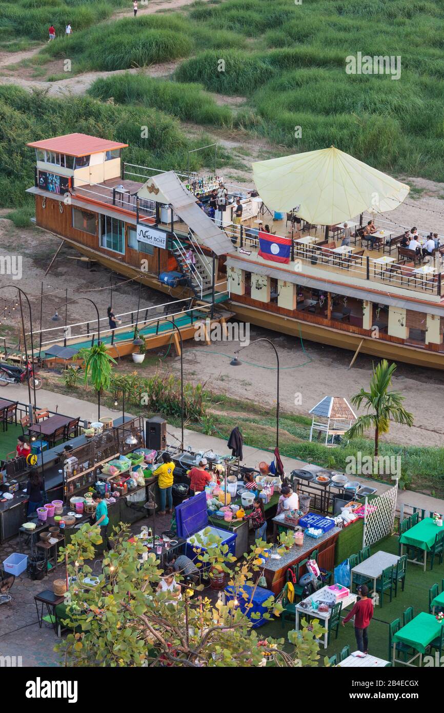 Laos, Vientiane, high angle view of Mekong Riverfront restaurant, dusk Stock Photo