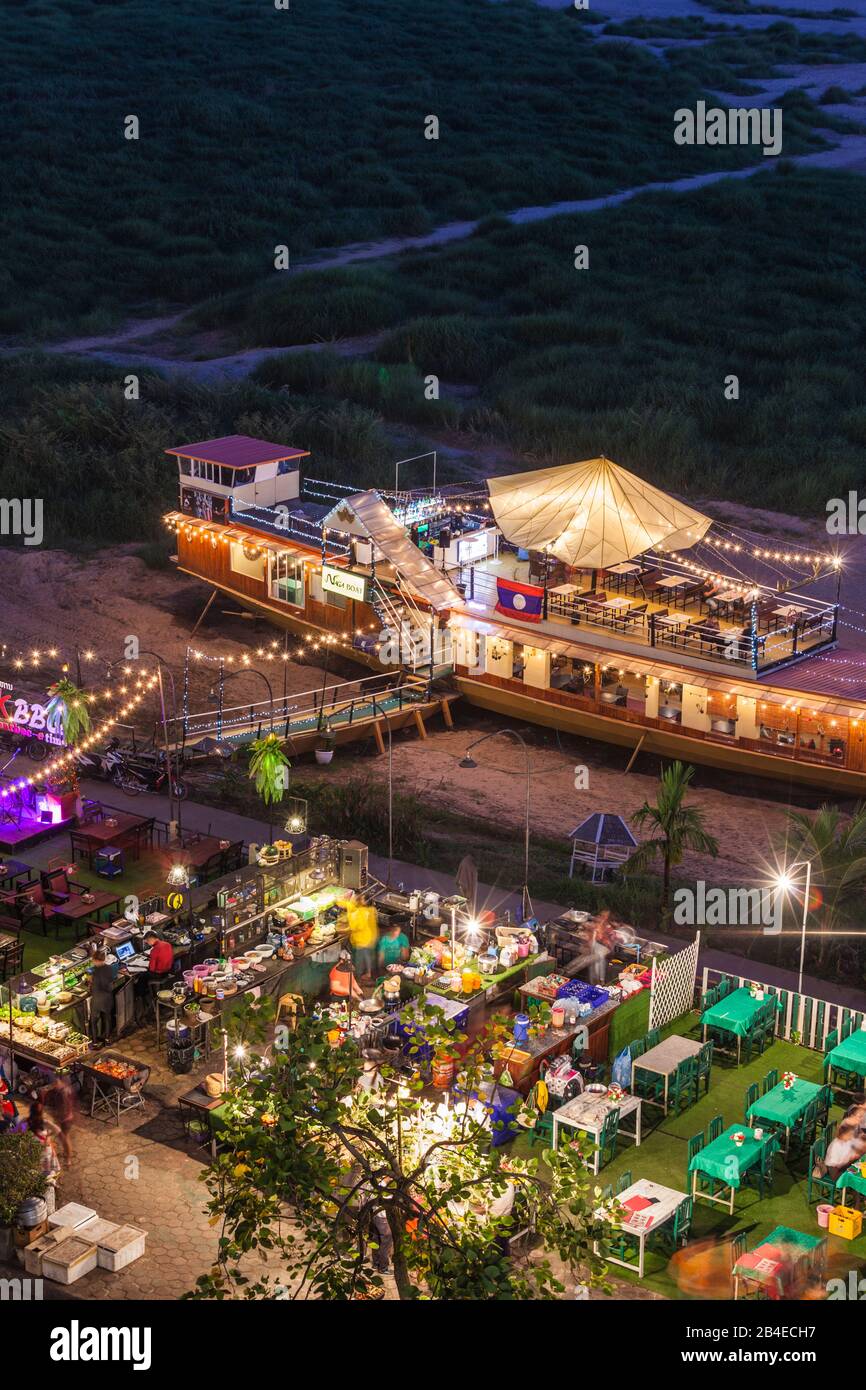 Laos, Vientiane, high angle view of Mekong Riverfront restaurant, dusk Stock Photo