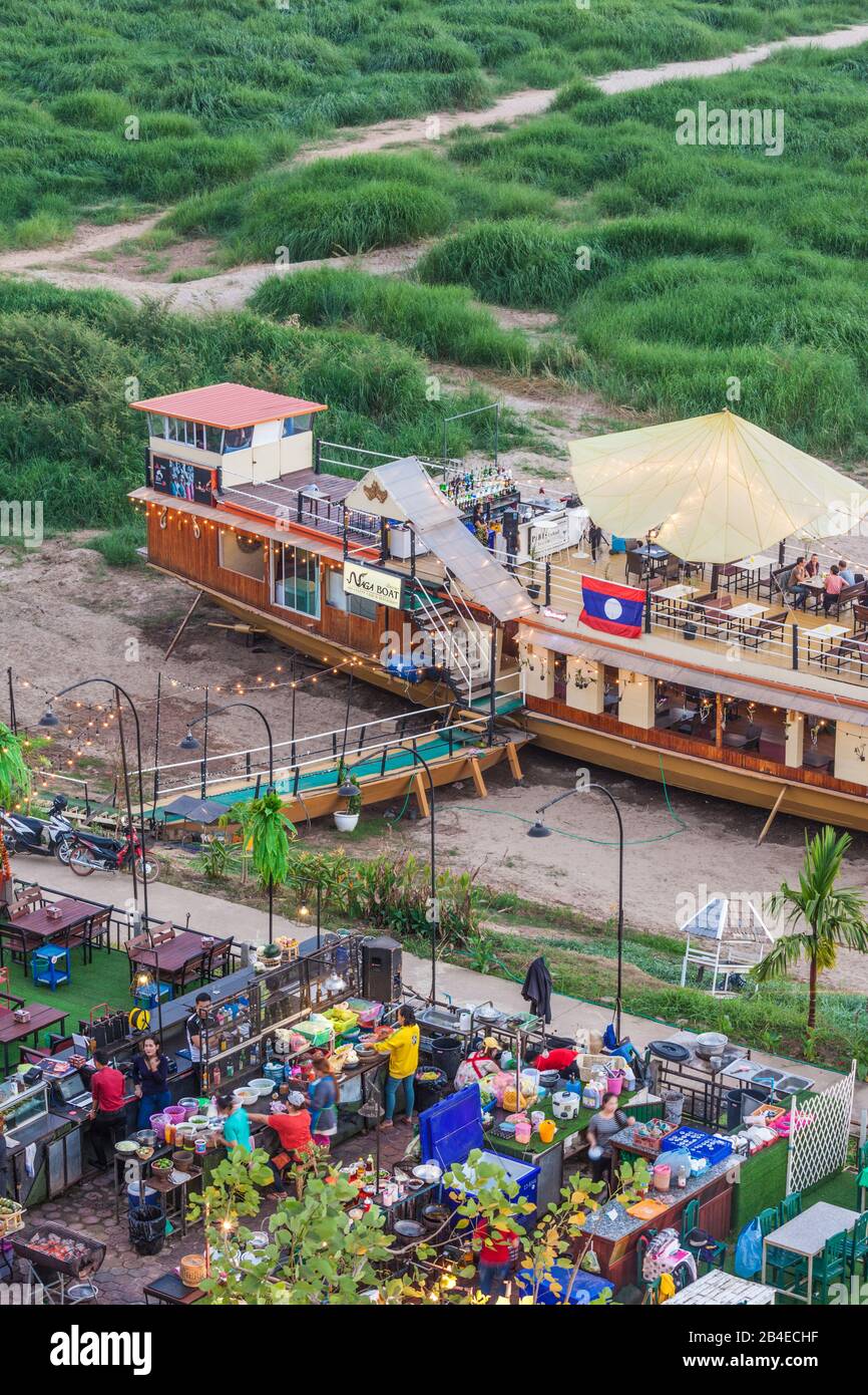 Laos, Vientiane, high angle view of Mekong Riverfront restaurant, dusk