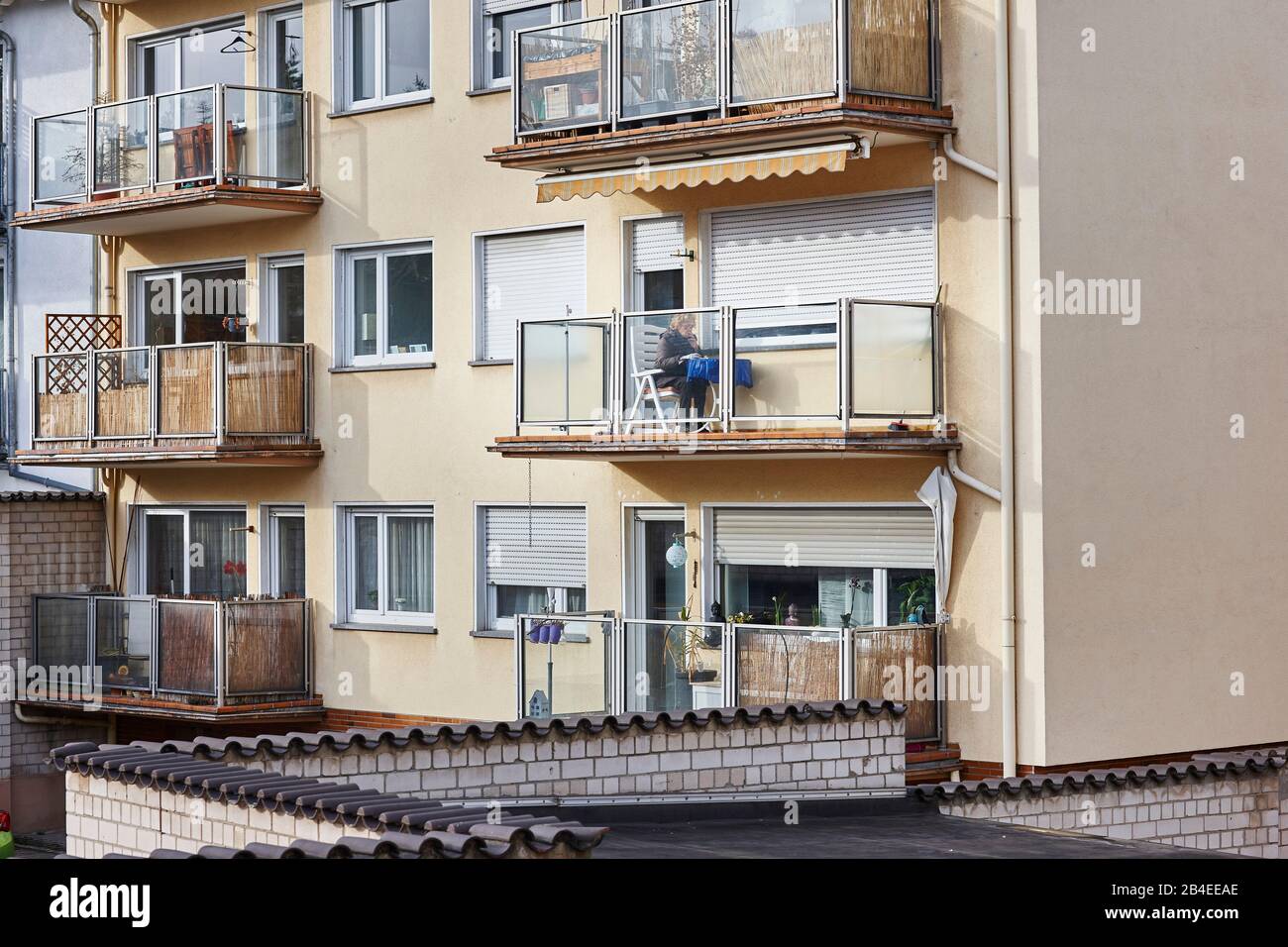 Europe, Germany, Hesse, Frankfurt, Bornheim, smoking woman on balcony Stock Photo