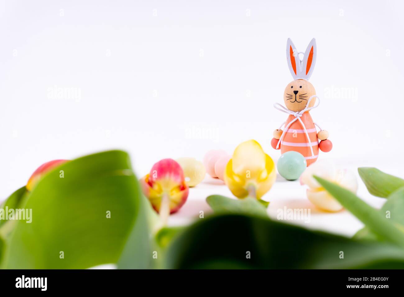 Colorful tulips laying in a row with easter eggs and a easter bunny on ...