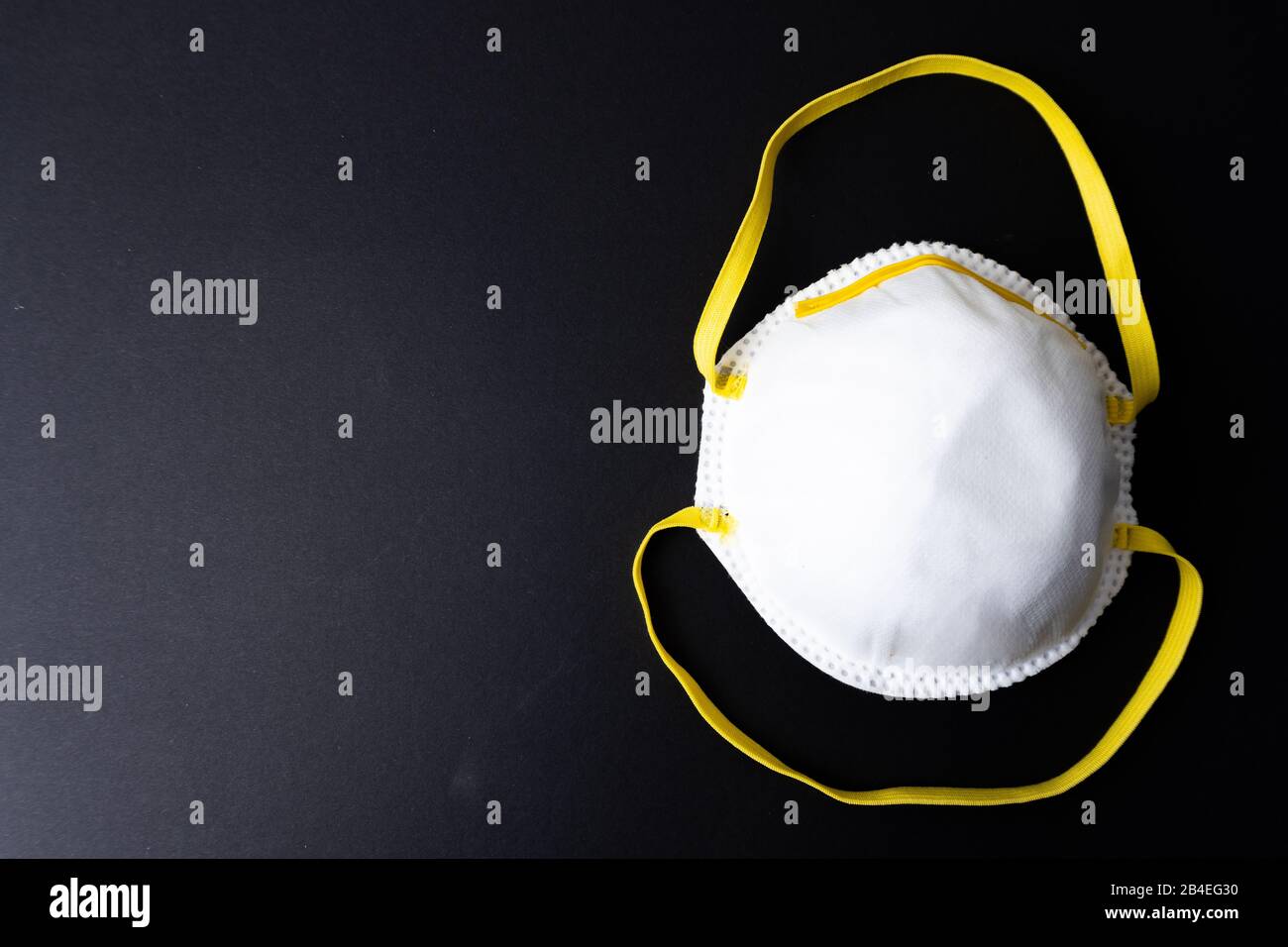 A white face mask on black background Stock Photo