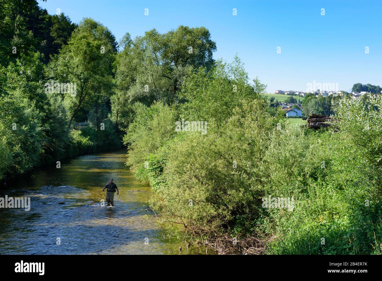 An asian female fly fisher women wearing waders and resting a rod on her  shoulder, as she looks where to fish on a river in Scotland Stock Photo -  Alamy