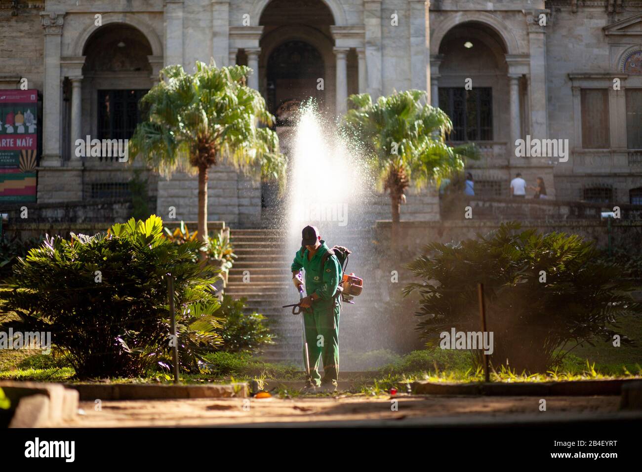 Sunlight streaming in in the gardens of Parque Lage school with the water of the fountain in front catching light Stock Photo