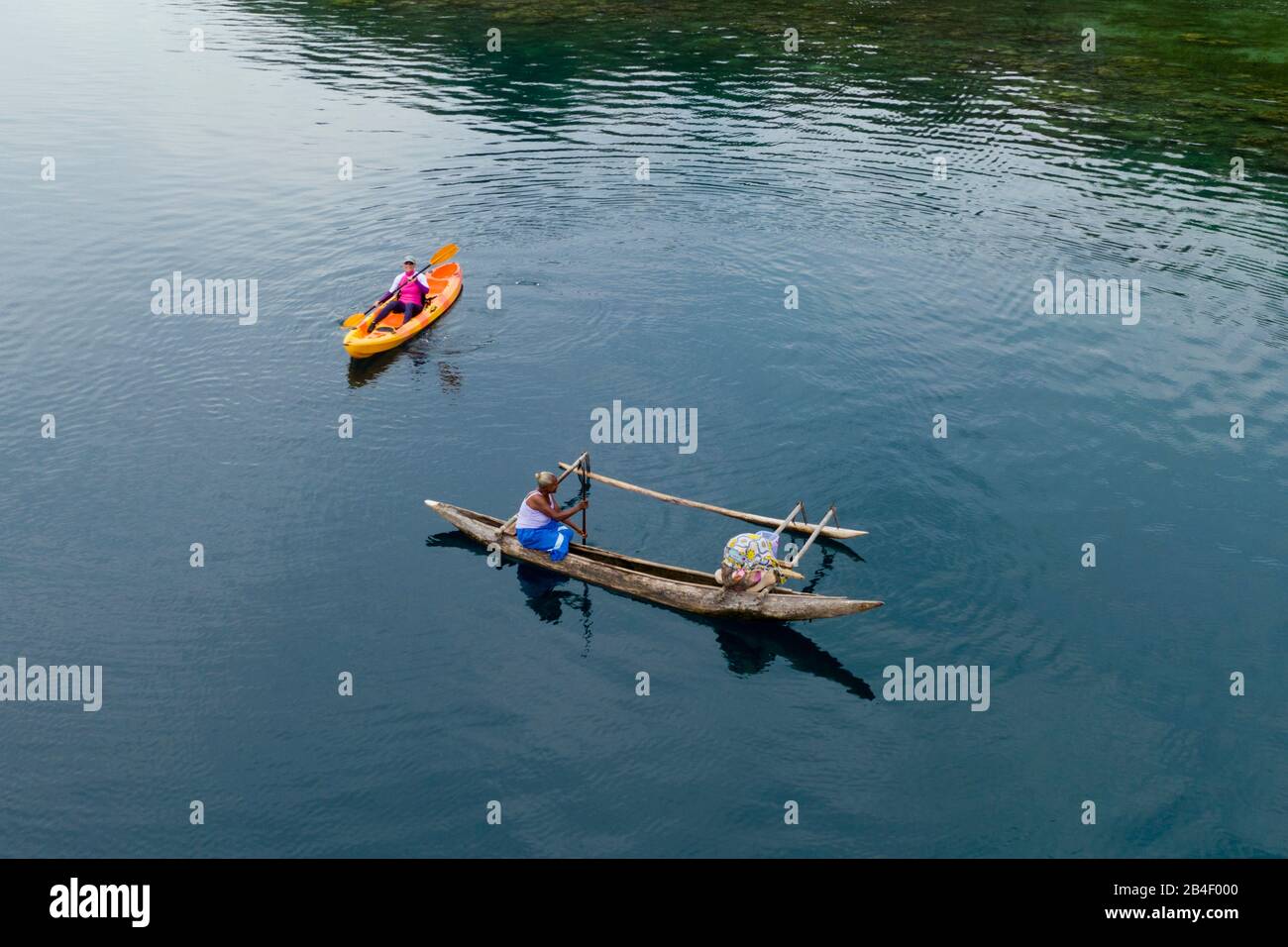 Women in Outrigger Canoe, Cape Nelson, Oro Province, Papua New Guinea Stock Photo