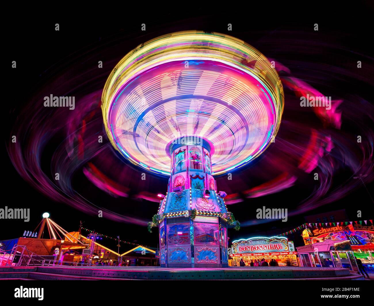 Folk festival, fair, rides, light trails, chain carousel Stock Photo