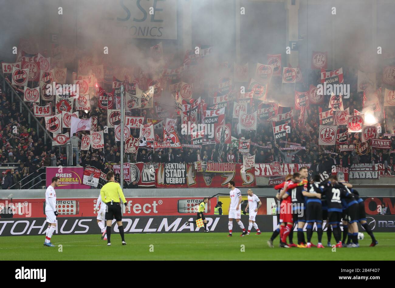 Paderborn, Germany. 06th Mar, 2020. Soccer: Bundesliga, SC Paderborn 07 -  1st FC Cologne, 25th matchday in the Benteler Arena. Fans from Cologne  ignite pyrotechnics at the start of the game. Credit: