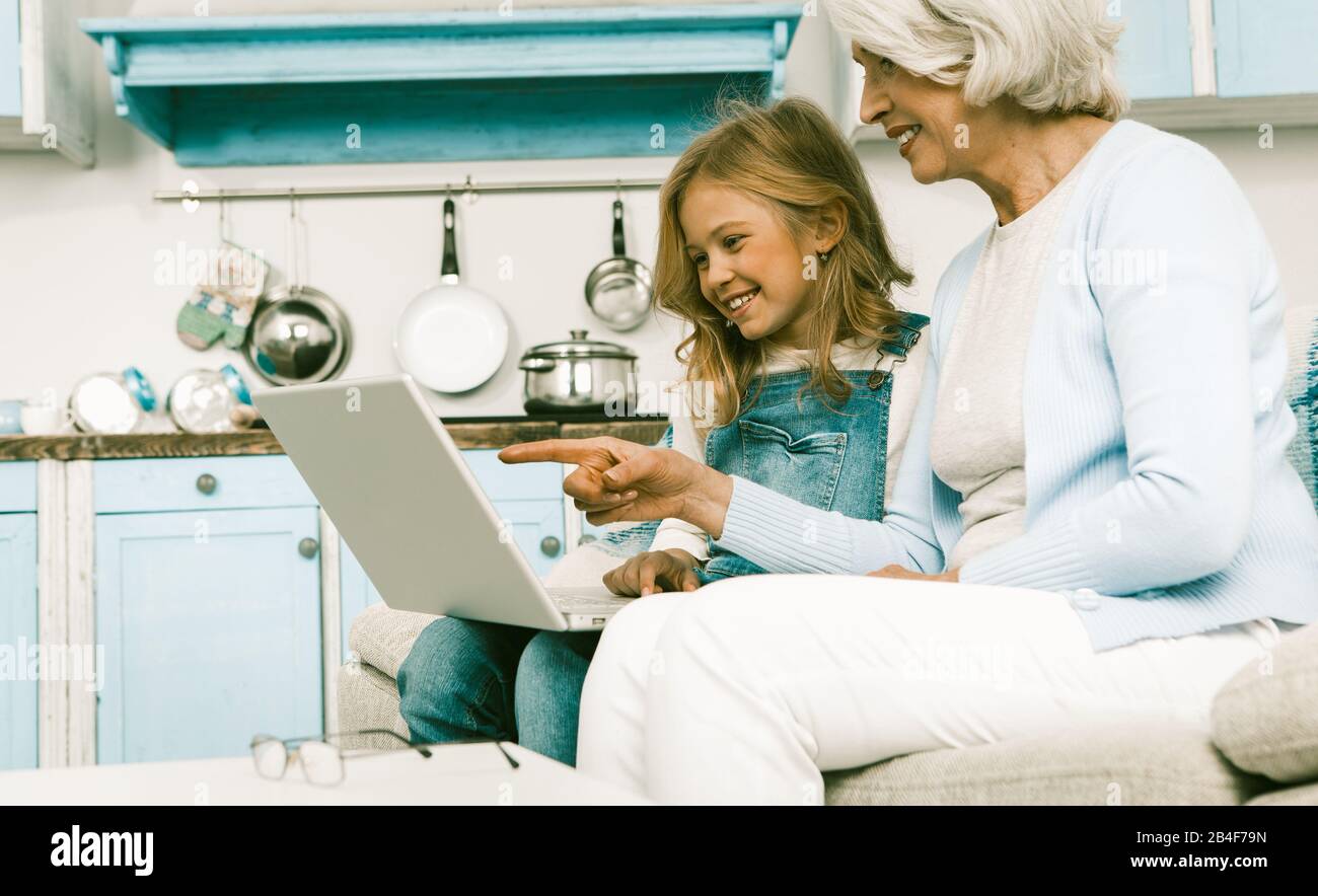 Happy Granny And Adorable Little Girl Using Laptop Stock Photo - Alamy
