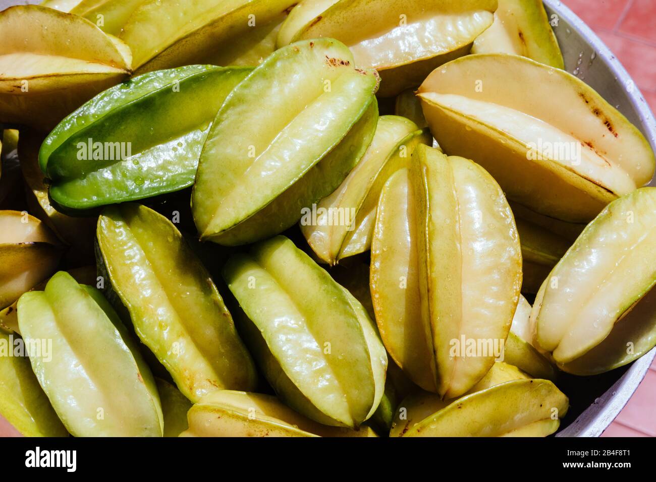 Close-up of fresh organic star fruit (Averrhoa carambola), aka carambola, washed ready to eat, outdoors Stock Photo