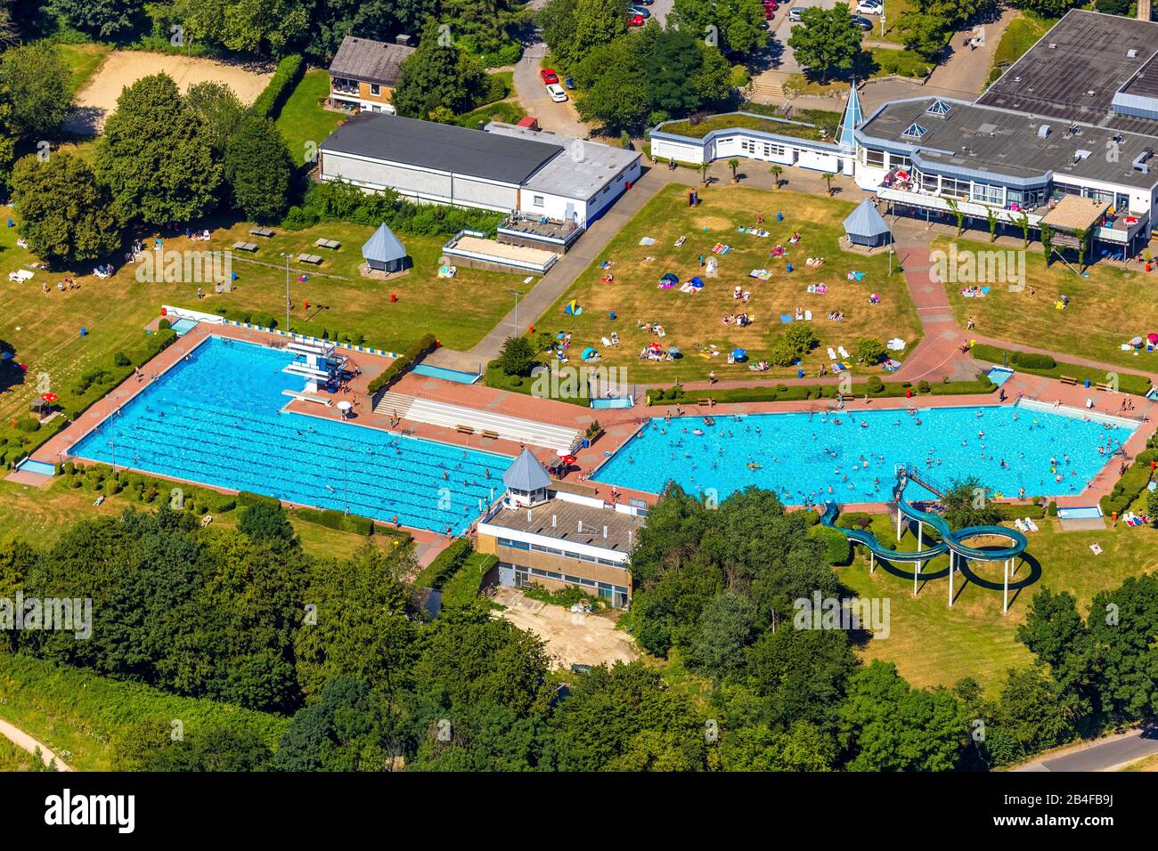Aerial view of the outdoor swimming pool and public swimming pool HeljensBad with swimmer pool, lap pool and sunbathing areas in Heiligenhaus in the Ruhr area in the federal state of North Rhine-Westphalia in Germany, Stock Photo