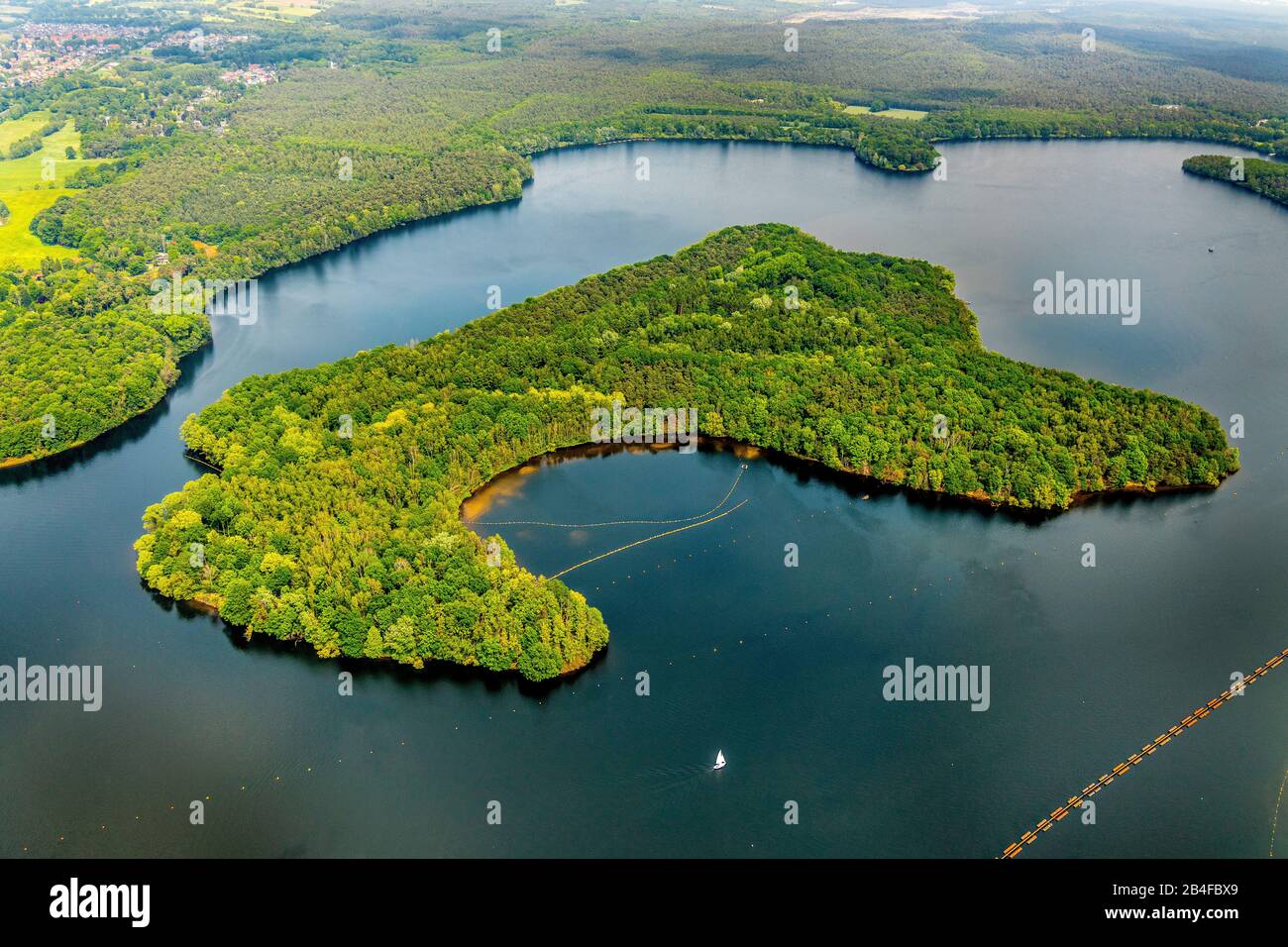 Aerial view of the green lake island with deciduous forest in Halterner reservoir in Haltern am See in the Hohe Mark-Westmünsterland Nature Park in the state of North Rhine-Westphalia, Germany Stock Photo