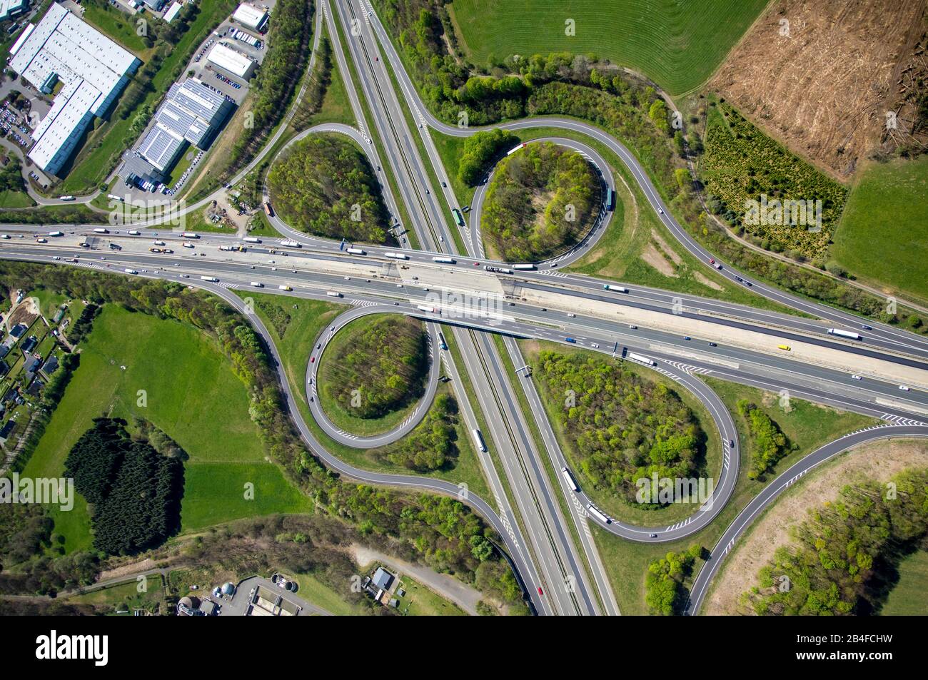 Aerial view of the motorway intersection Olpe, interchange Wenden with motorway A45 Sauerlandlinie and motorway A4 in form of a shamrock in Wenden in the Sauerland in the federal state of North Rhine-Westphalia, Germany. Stock Photo