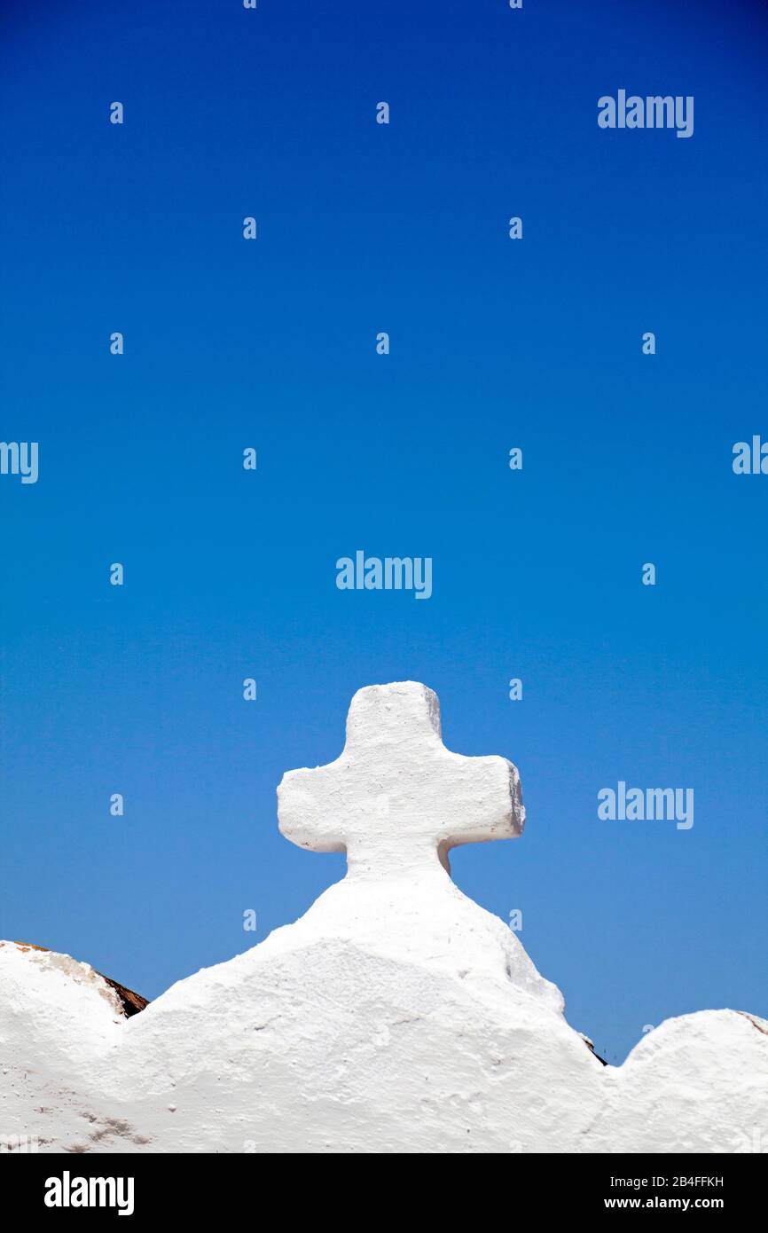 Stone white cross in front of blue sky, Sivota, Epirus, Northern Greece, Greece Stock Photo
