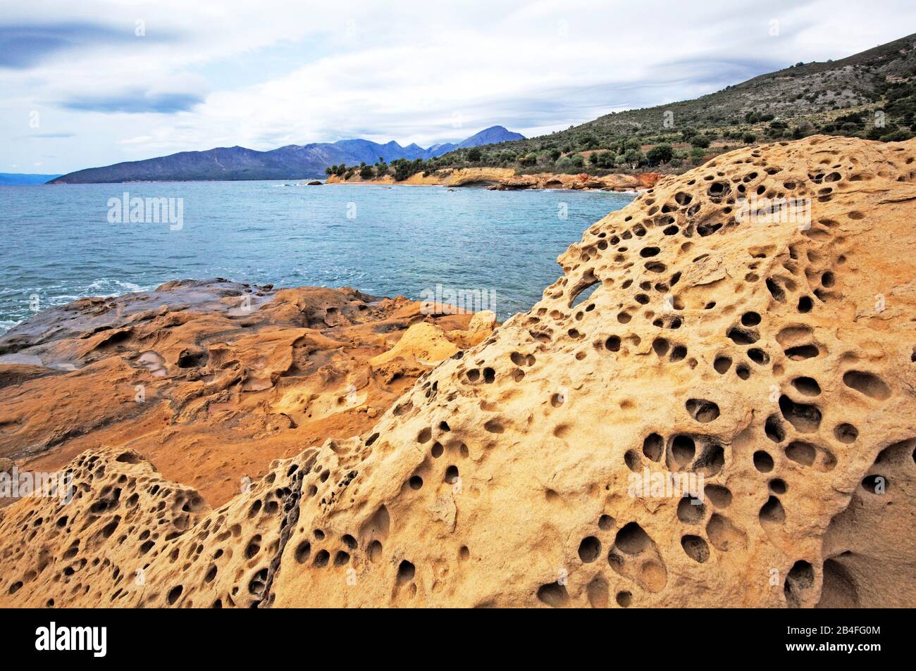 Holes in the sandstone of former sea creatures, Greece Stock Photo