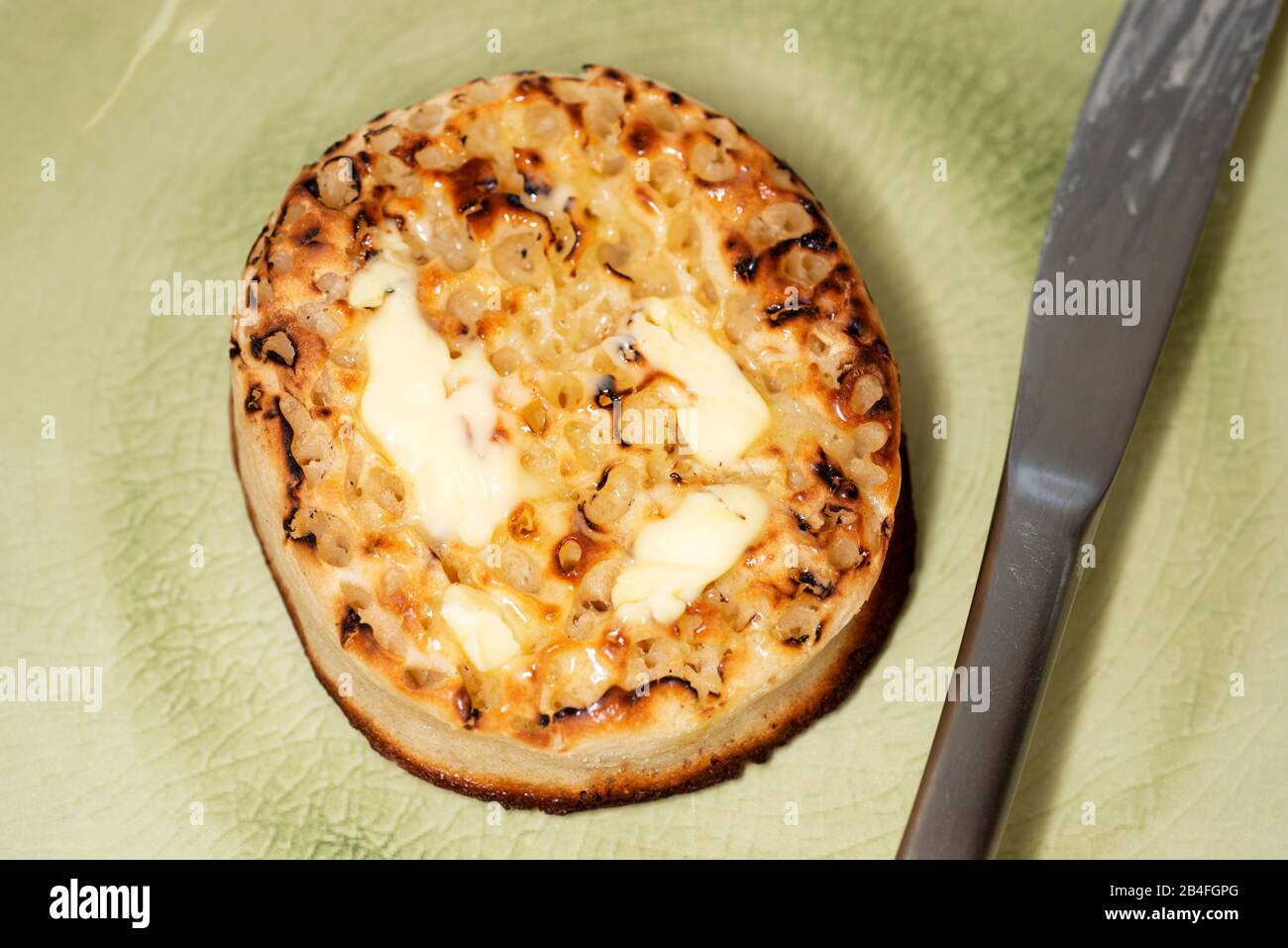 Buttered toasted crumpet Stock Photo