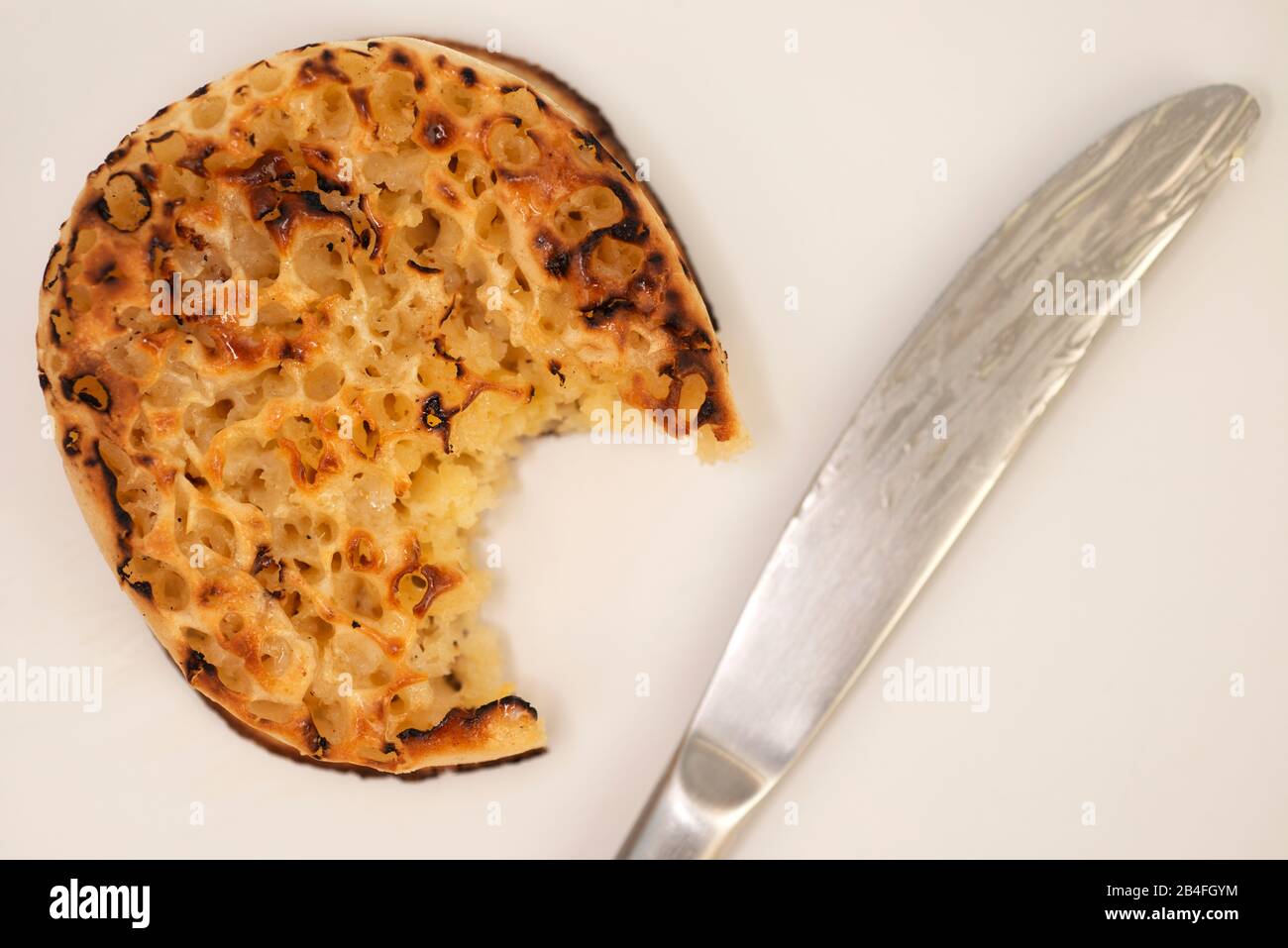 Buttered toasted crumpet Stock Photo