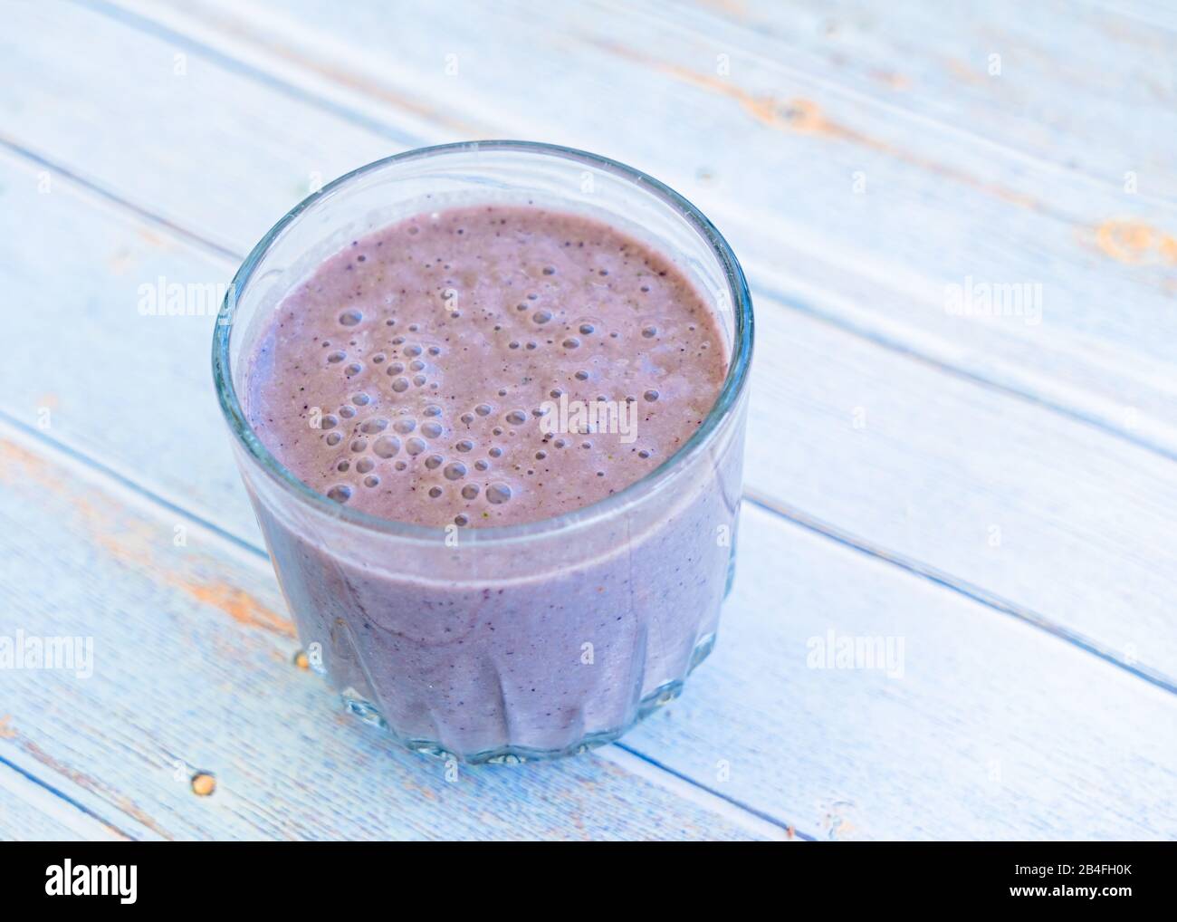 Strawberry blueberry kale smoothie in a glass. Stock Photo
