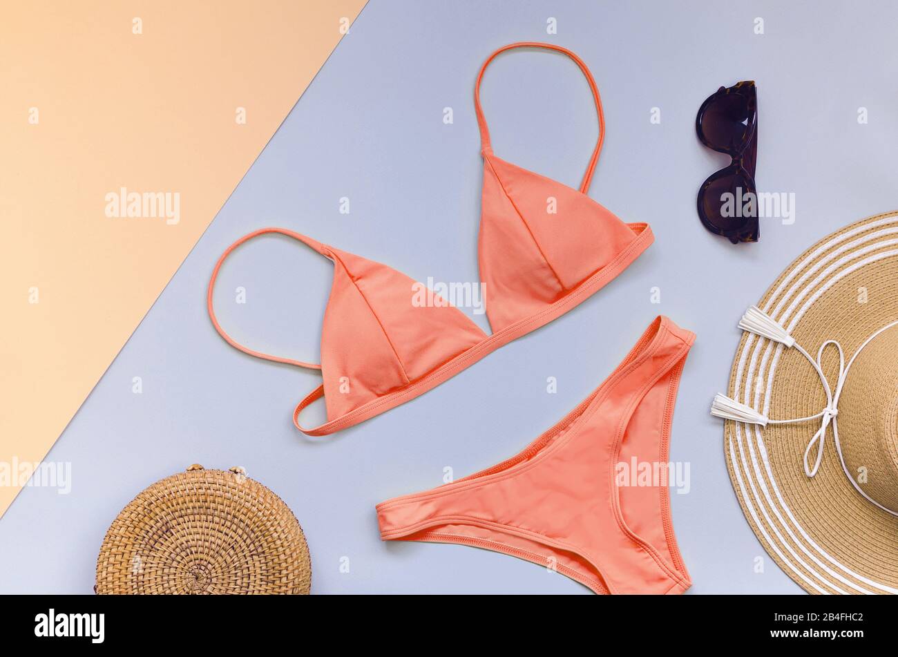 Swimming suit with sunglasses, bag and straw hat for summer. Flatlay Stock Photo