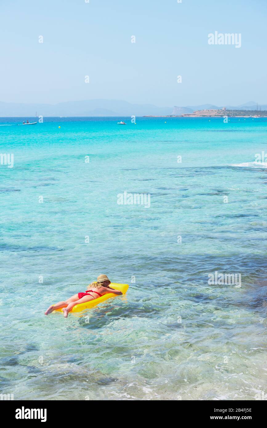 Woman relaxing on inflatable mattress,  Formentera, Balearic Islands, Spain Stock Photo