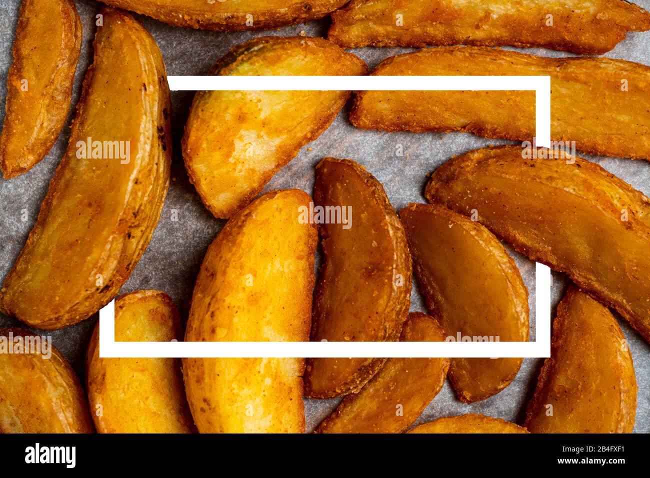 Rustic fried potato on paper background with white abstract frame. Top ...