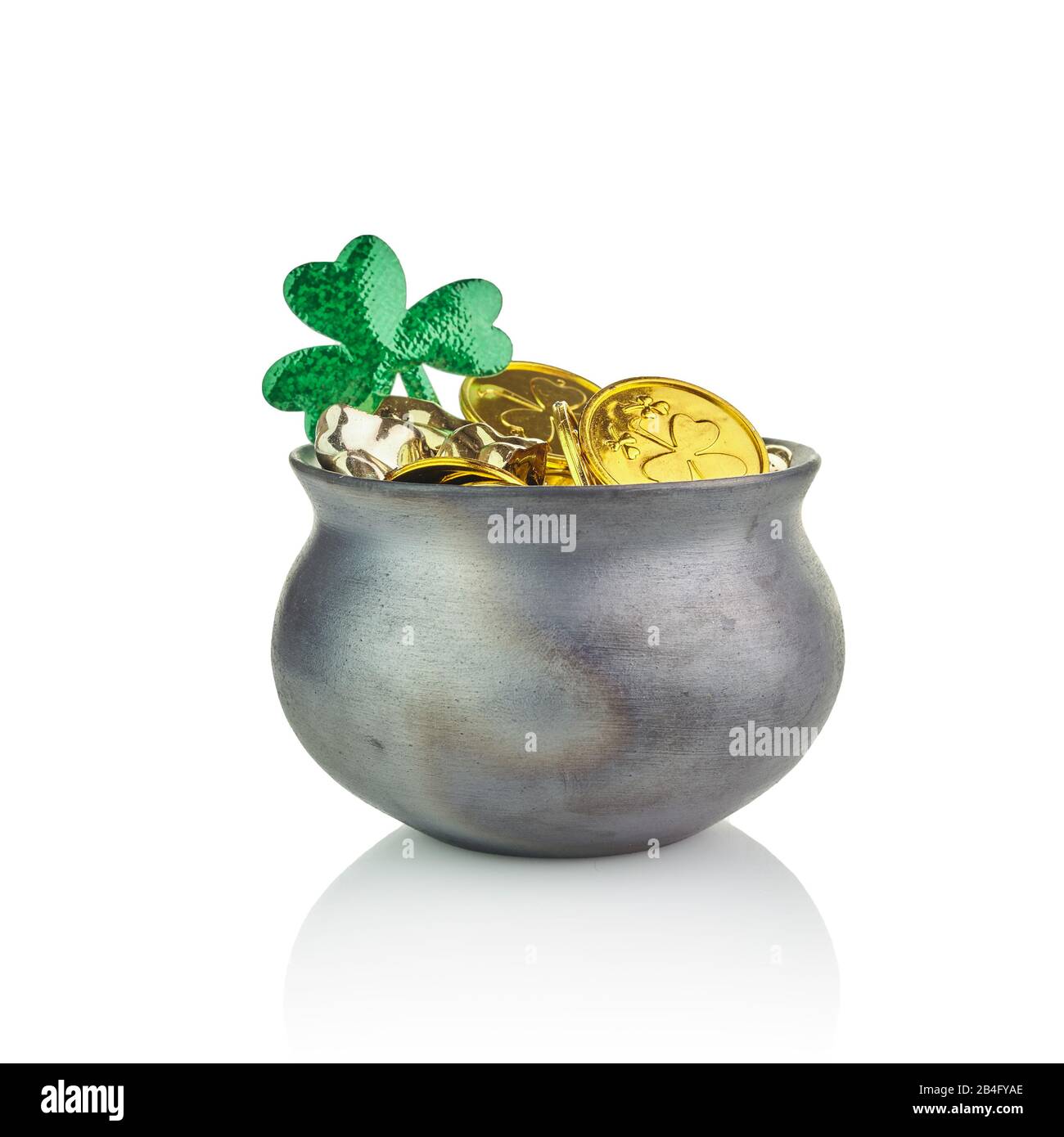 Black pot of leprechauns gold with lucky clovers isolated on white Stock Photo
