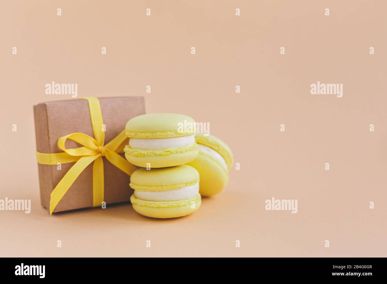 Download Yellow Macarons With Gift Box On A Peach Pastel Background Lemon Macarons Place For Text Stock Photo Alamy PSD Mockup Templates