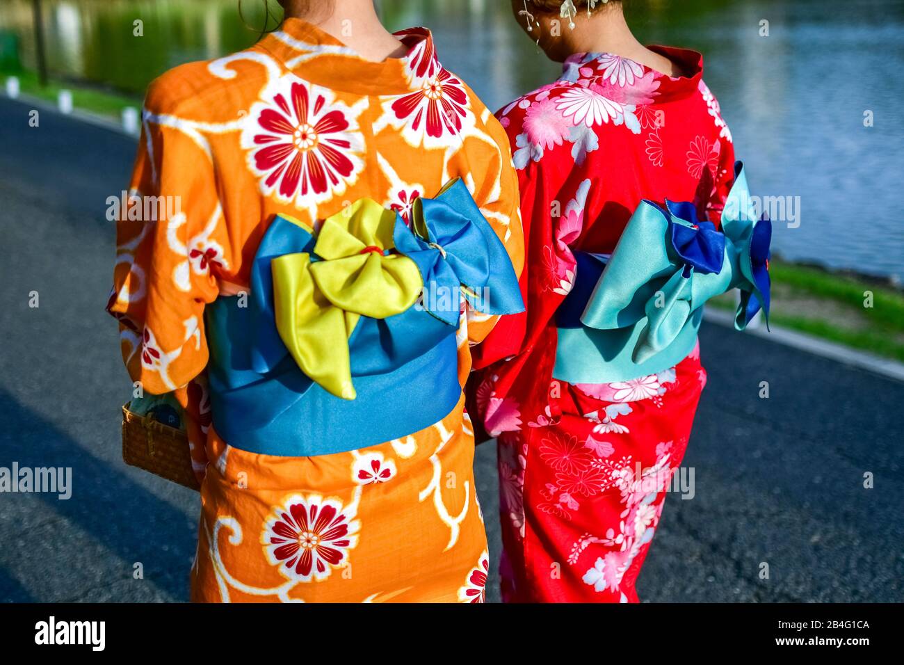 Young women wearing traditional Japanese dress at Sarasawaike Pond, Nara, Honshu, Japan Stock