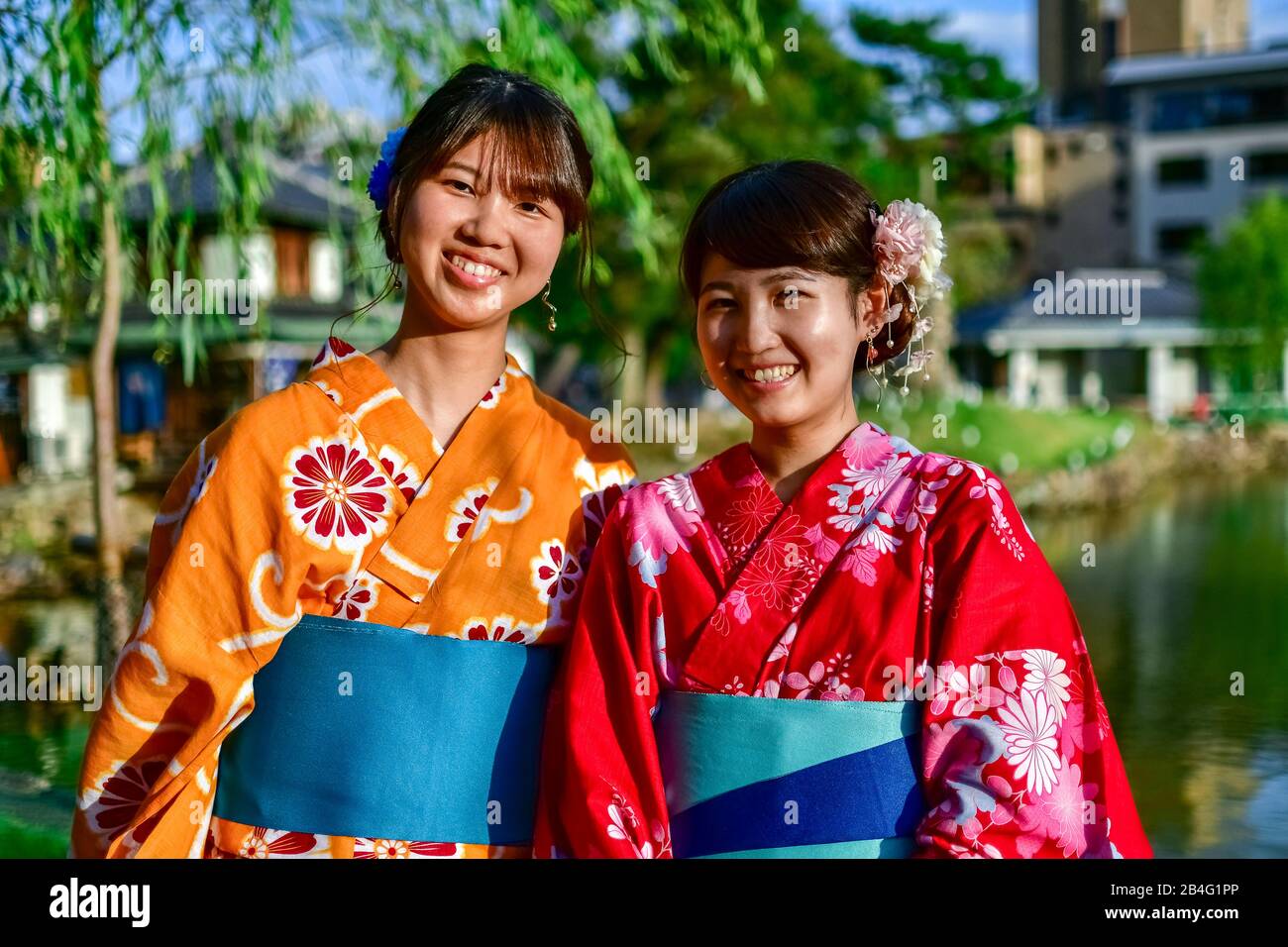 Young women wearing traditional Japanese dress at Sarasawaike Pond, Nara, Honshu, Japan Stock