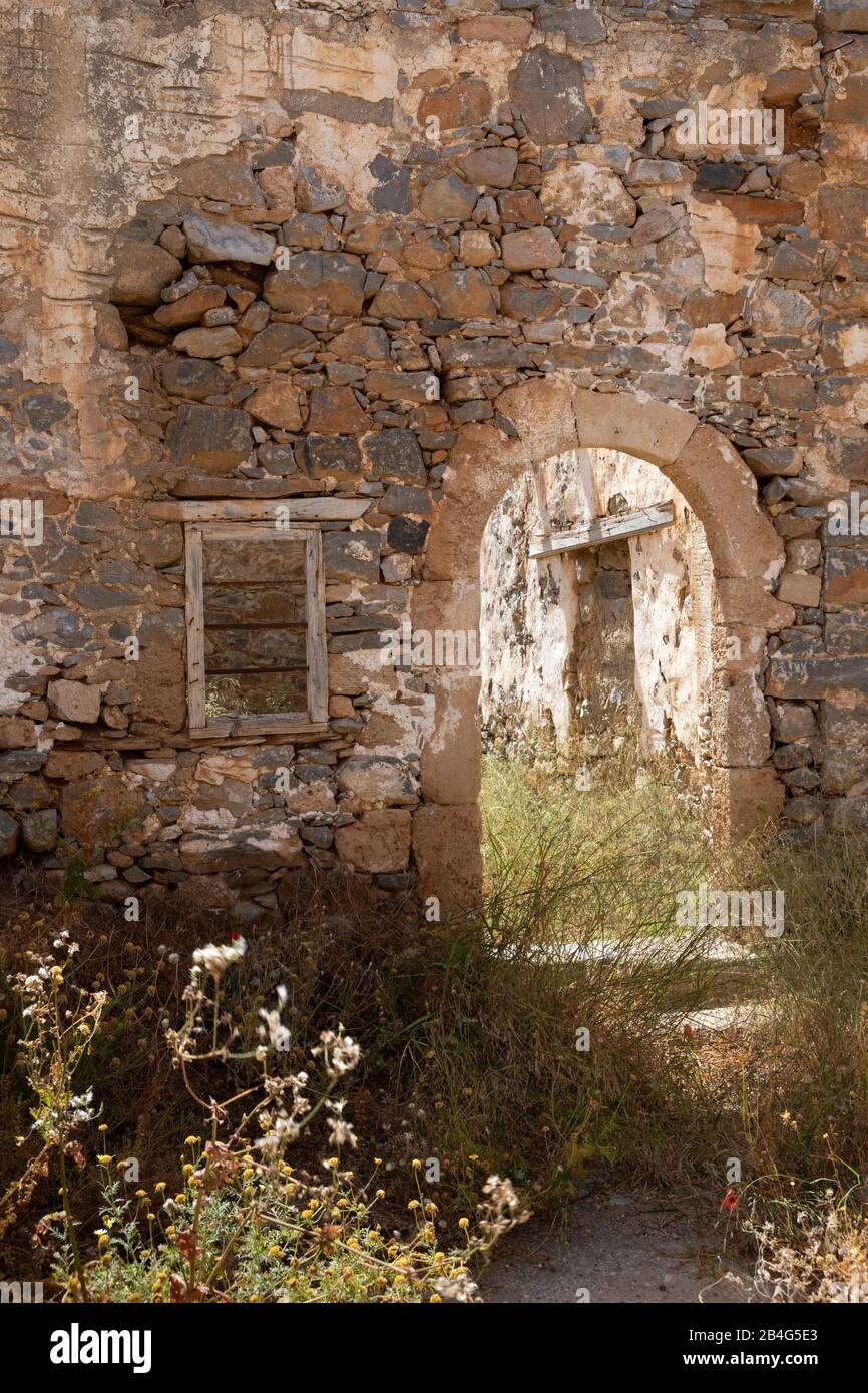 Archway and window of a ruined house on the leprosy island Spinalonga ...