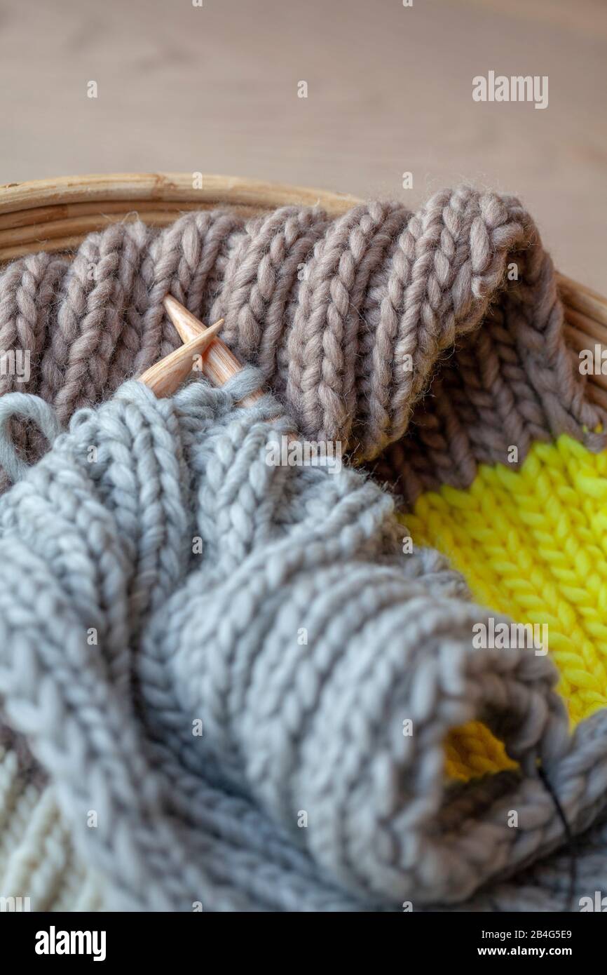 Knitting with fluffy wool and thick needles in basket Stock Photo Alamy