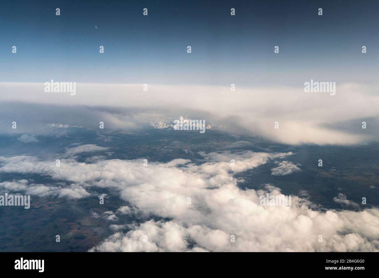 flight, aerial view, Cumulus incus and Cumulonimbus calvus, thunderclouds, moon Stock Photo