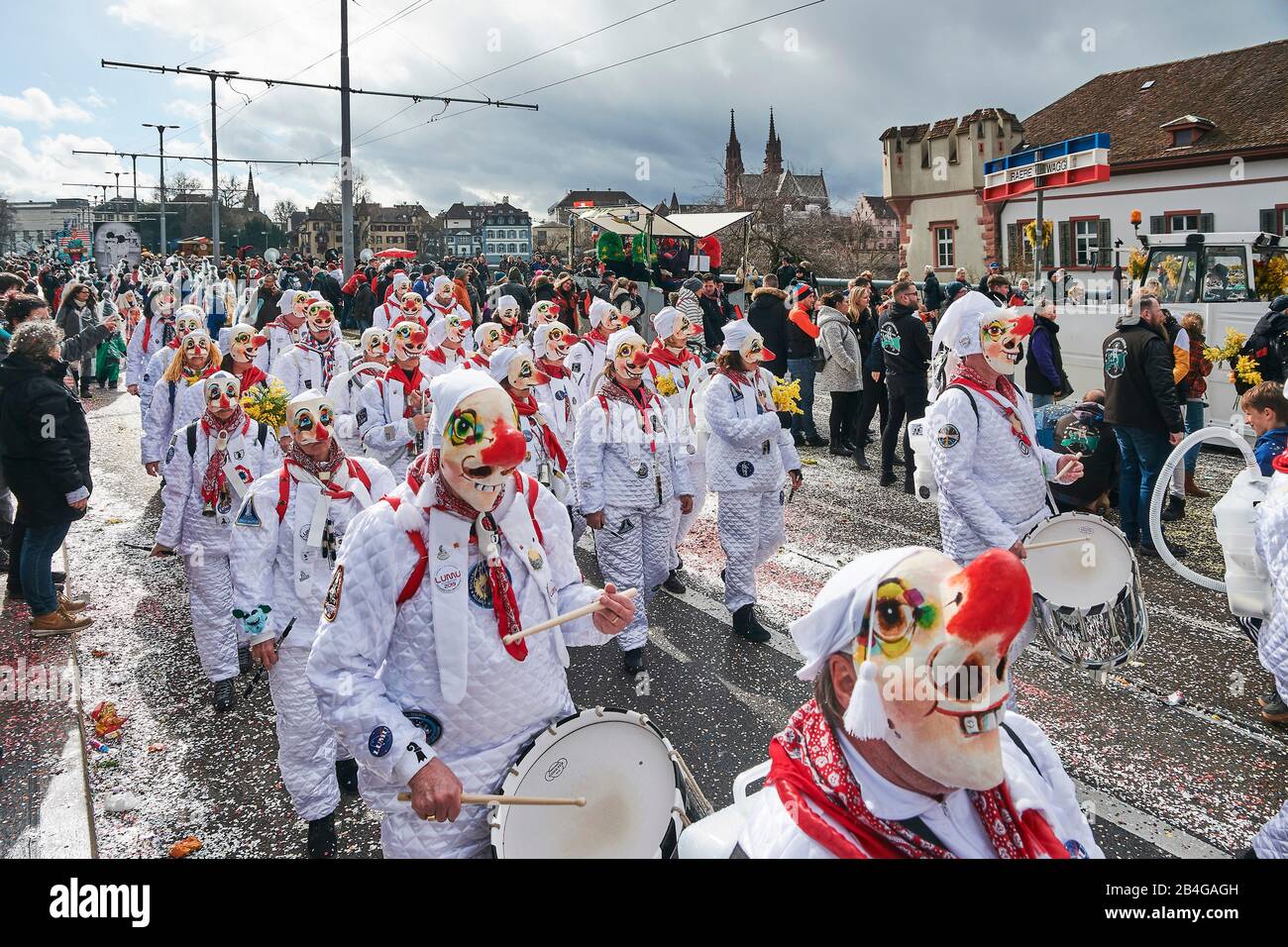 Europe, Switzerland, Basel, Traditional event, Basel Fasnacht, the largest in Switzerland, intangible cultural heritage of humanity, Cortège on the Wettstein Bridge, Guggenmusik, Basel Minster in the background Stock Photo