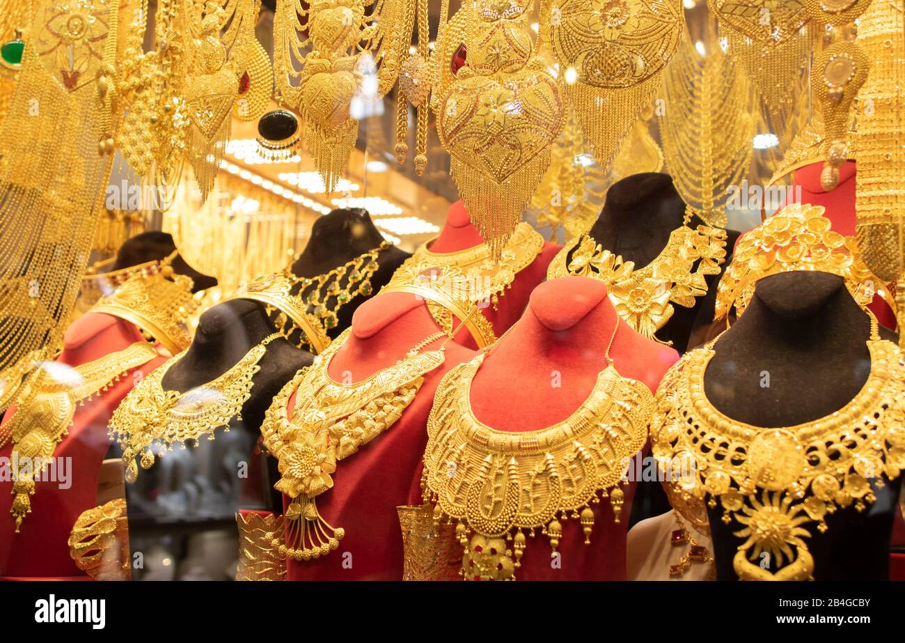 Gold necklaces and bracelets designed in various ways in front of the