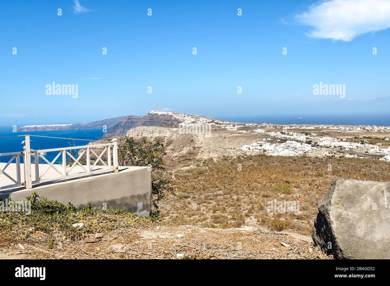 Summer day view of the whitewashed towns of Oia and Fira and desert landscape, sea and cliffs on the Aegean island of Santorini, Greece. Stock Photo