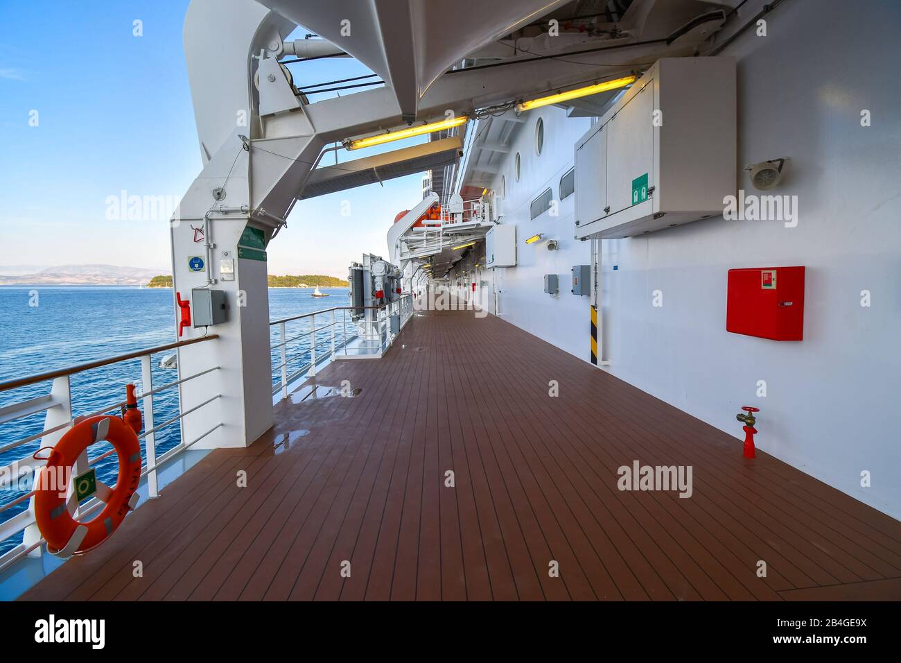 The empty outer deck of a cruise ship with no identifiable features cruising the Aegean Sea on a summer day. Stock Photo