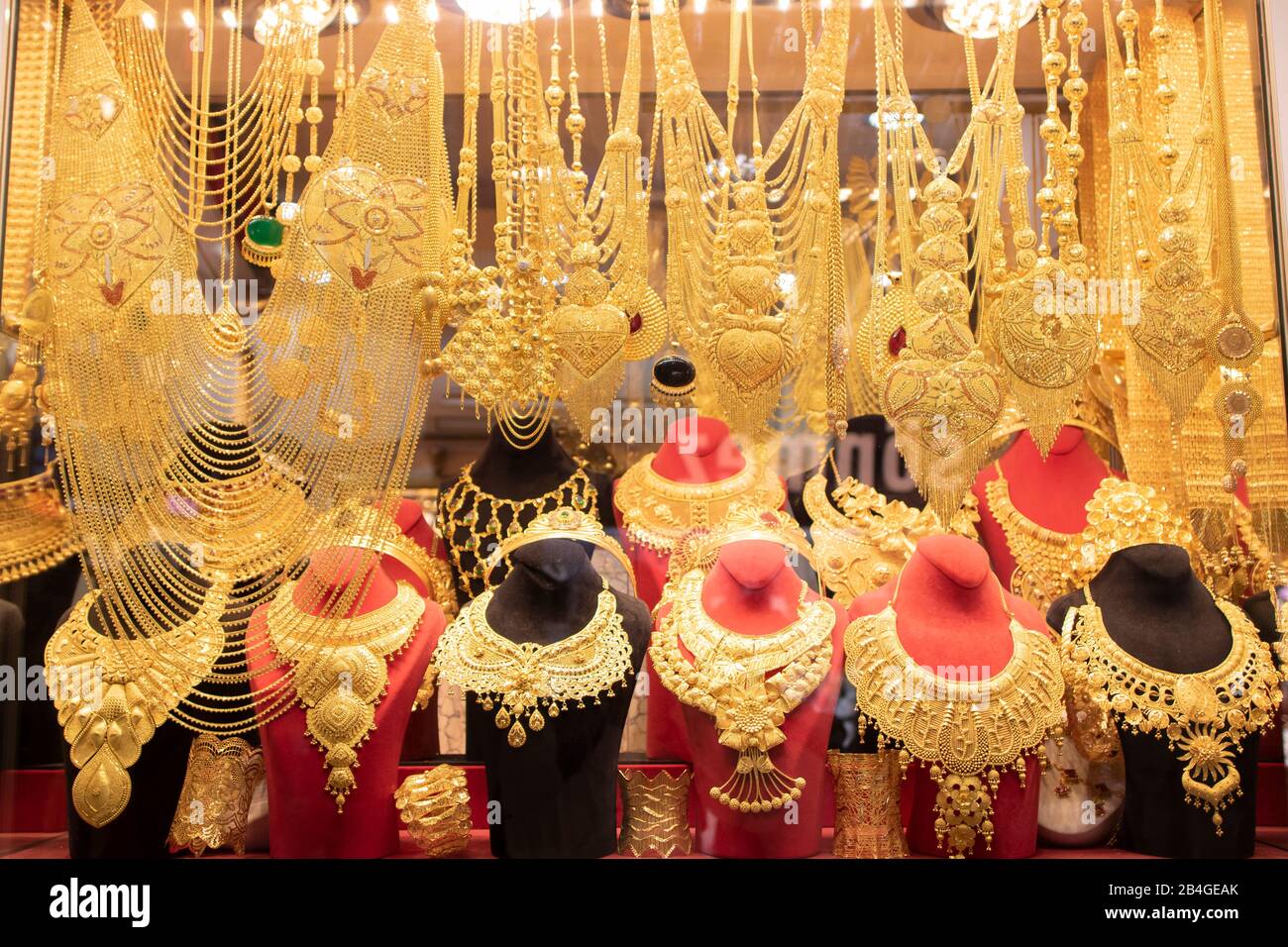 Gold necklaces and bracelets designed in various ways in front of the