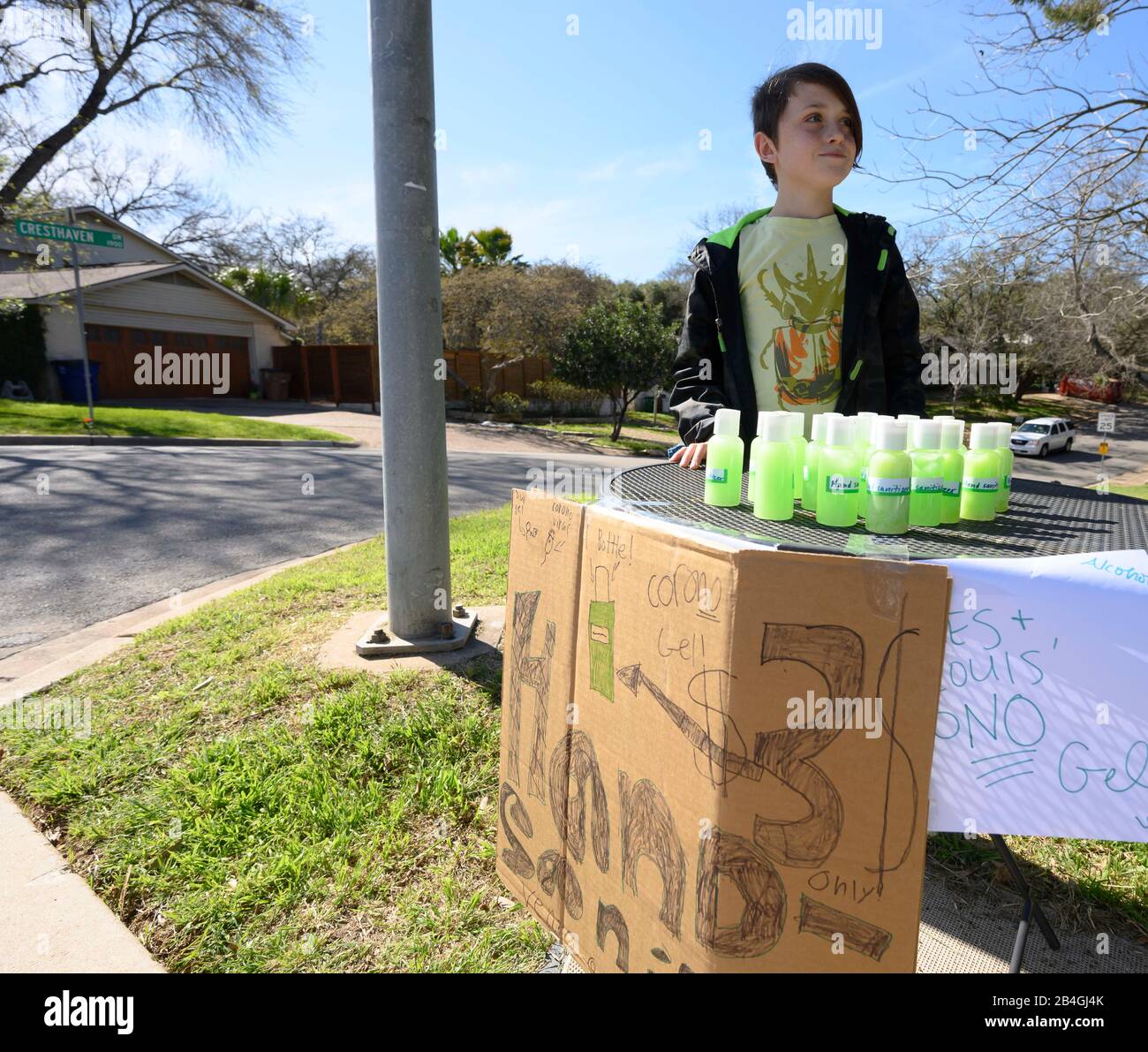Hand sanitizer stand replaces lemonade stand as entrepreneur Miles Miller sells homemade hand sanitizer to help combat coronavirus at $3 a bottle in his Austin, Texas, neighborhood after school. Stock Photo