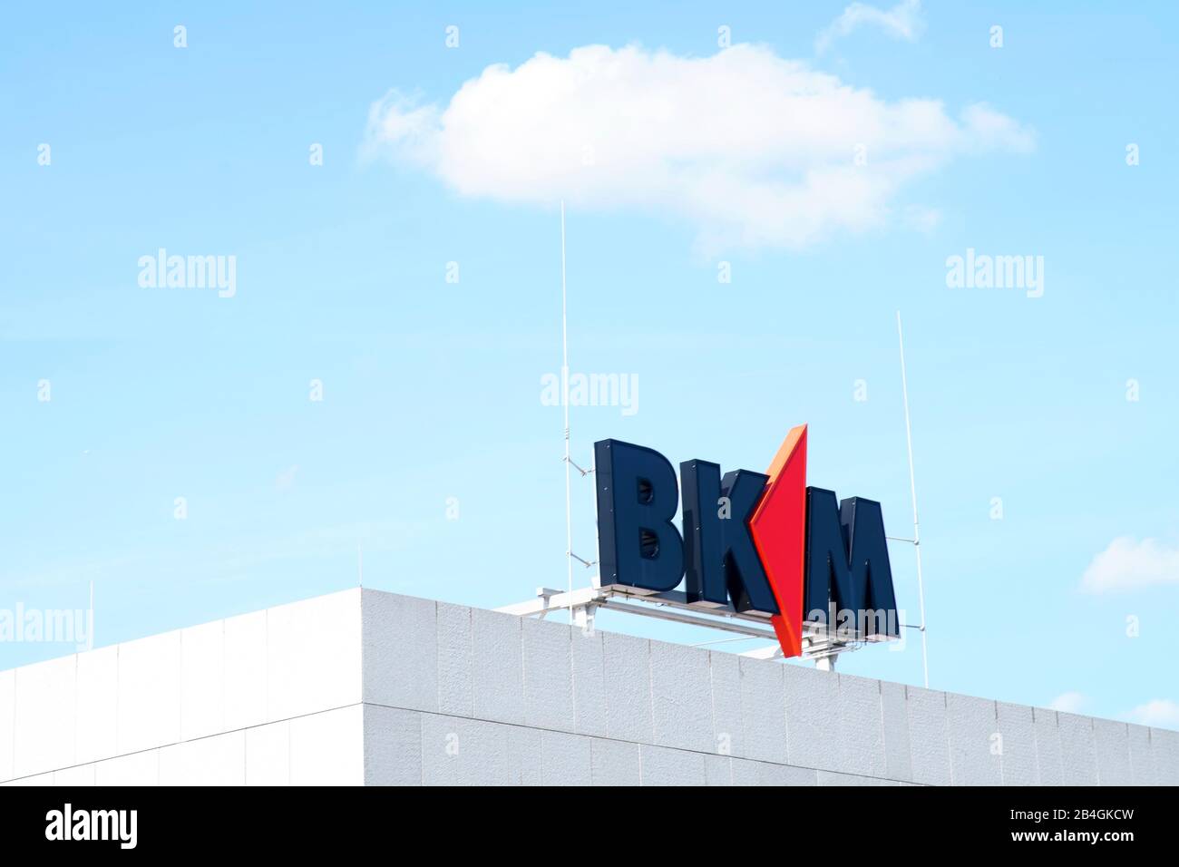 The logo of Bausparkasse BKM Mainz on the roof edge of a business building in Mainz. Stock Photo