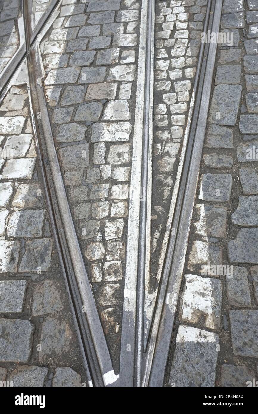 Street car rails coming together near the switch on marked crosswalk. Prague, Czech Republic Stock Photo