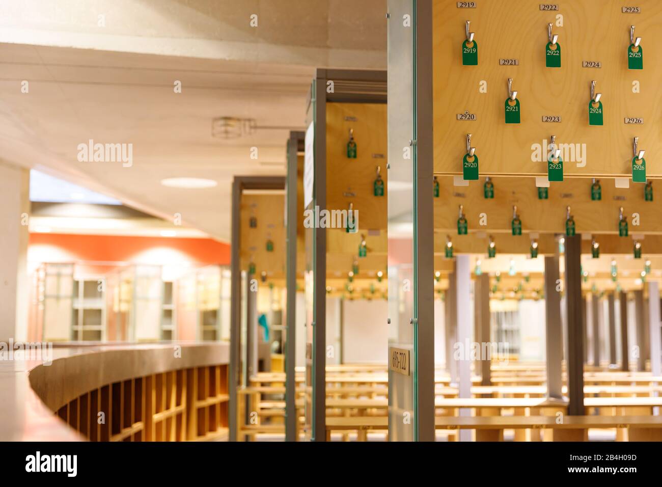 Empty cloakrooms service with green number tags. Hooks with numbers in theatre. Dressing room Stock Photo