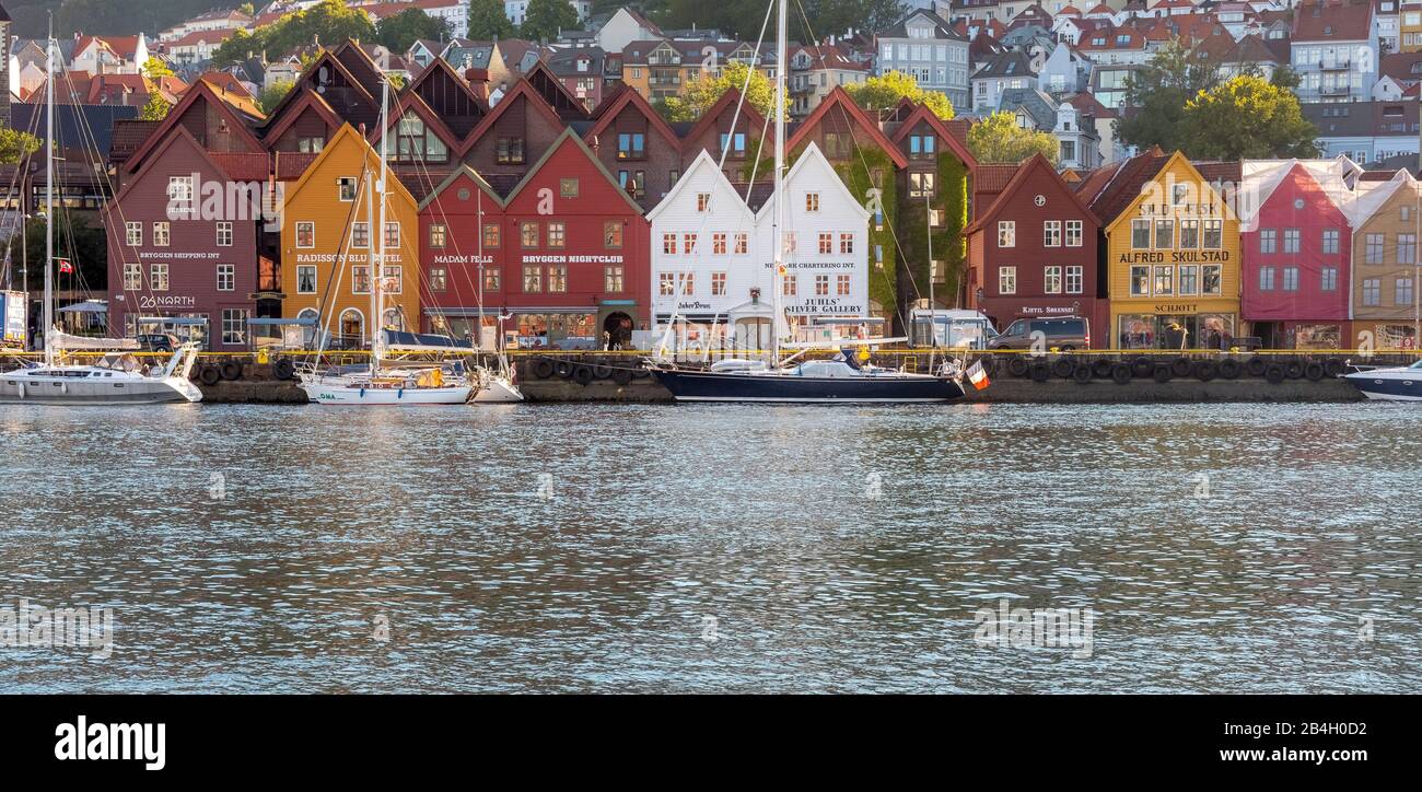 colorful, historic wooden houses in the harbor of the city of Bergen, sailing ships, Hordaland, Norway, Scandinavia, Europe Stock Photo